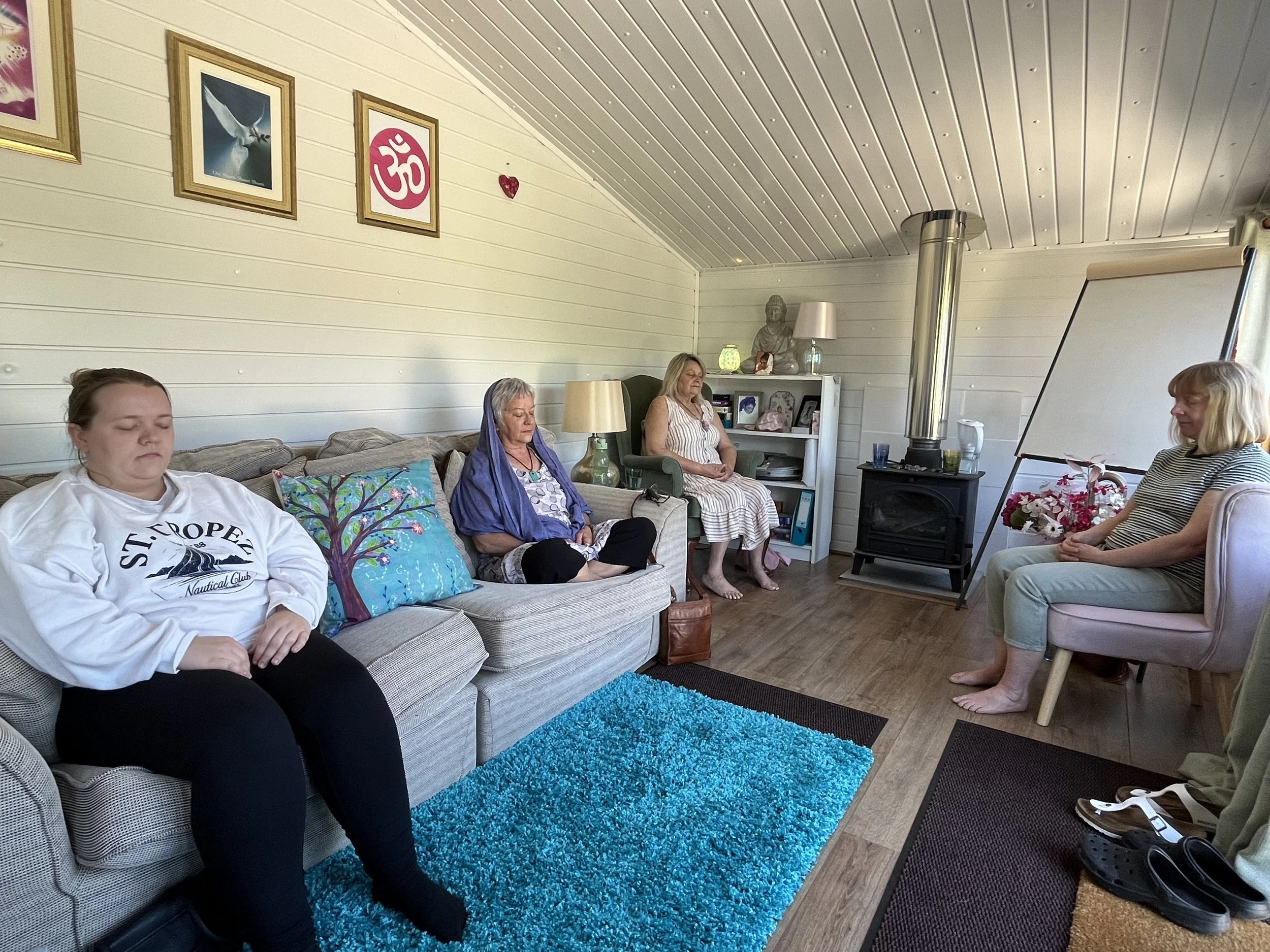 A group of four students practicing mindfulness meditation during a course in Point Clear serving Colchester.