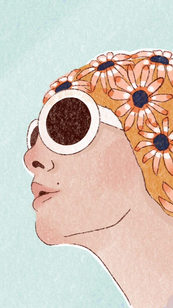 Side profile of a woman with flower-shaped hair accessories and wearing round sunglasses.