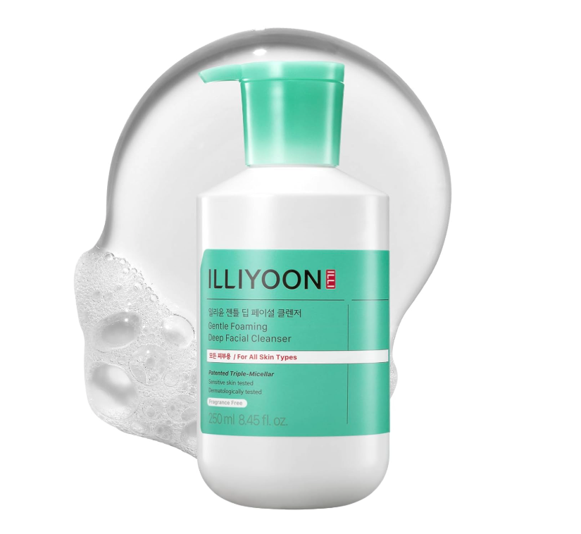 A white bottle of Illyoon Gentle Foaming Deep Facial Cleanser with a green pump, in front of a transparent splash of foam.