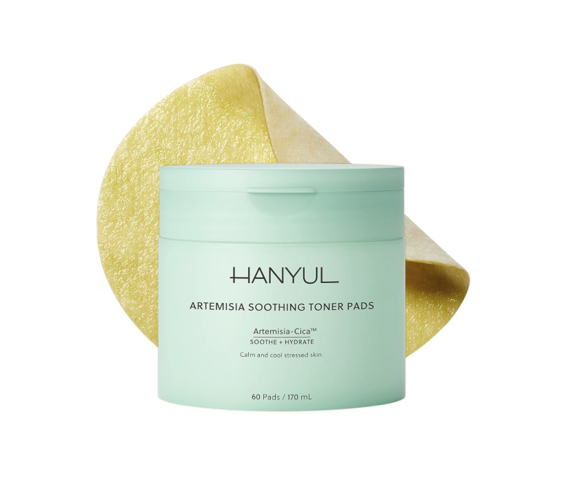 Container of HANYUL Artemisia Soothing Toner Pads with Artemisia-Cica for calming and hydrating stressed skin, accompanied by a slice of Artemisia plant in the background.