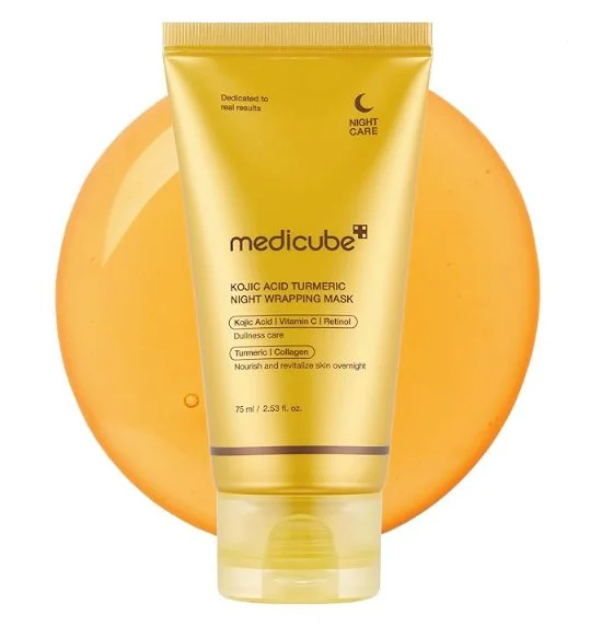 Gold tube of Medicube Kojic Acid Turmeric Night Wrapping Mask in front of an orange gel-like background.