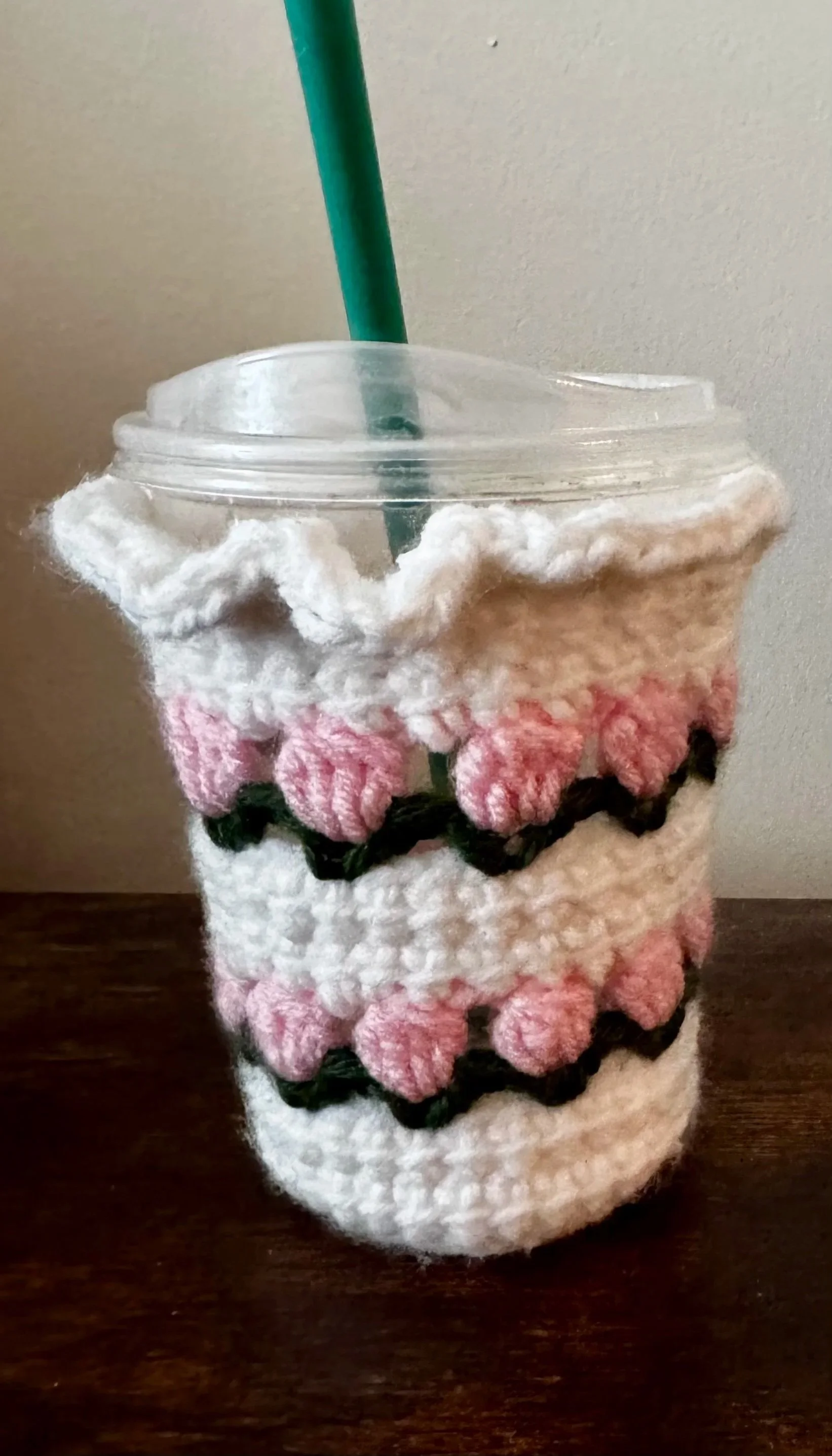 A plastic cup decorated with a crocheted face, Crochet pattern, coffee coozie