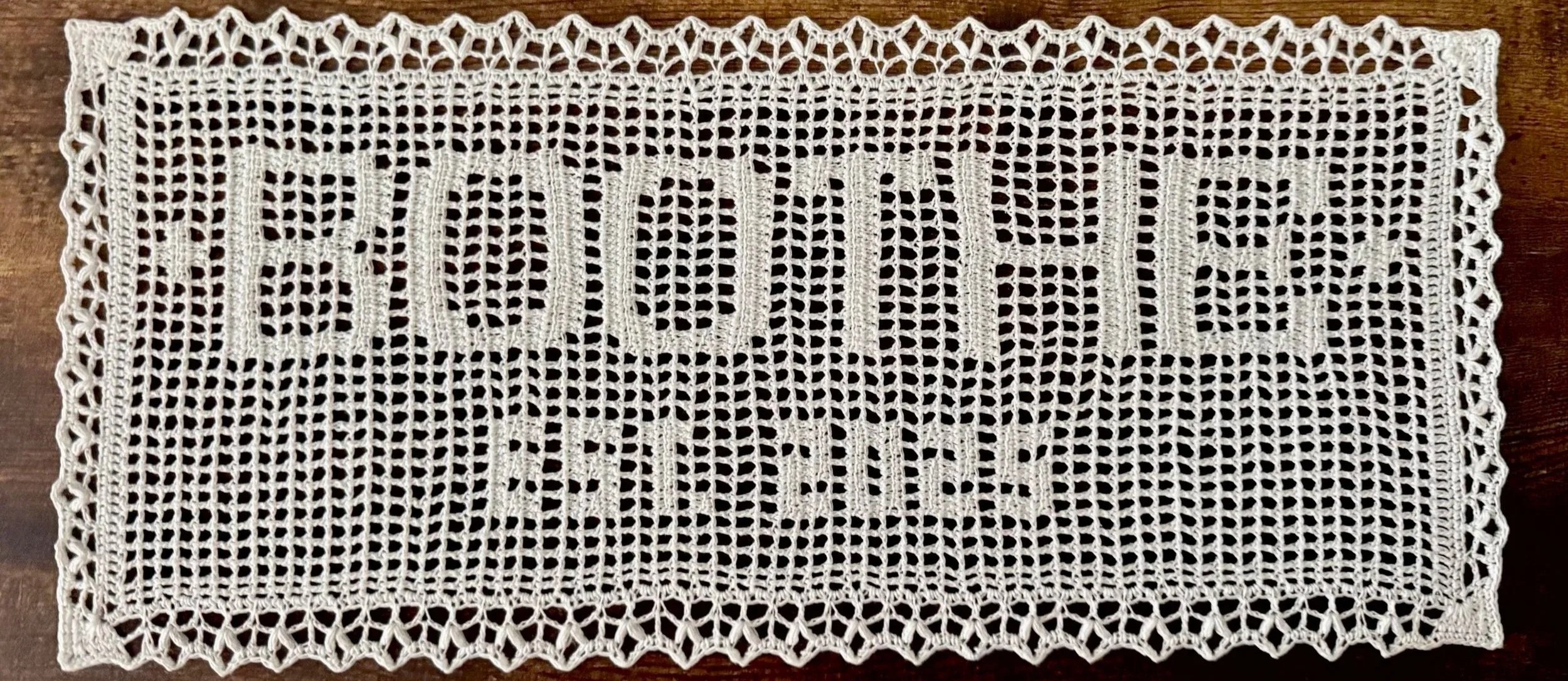 A rectangular white lace Name doily