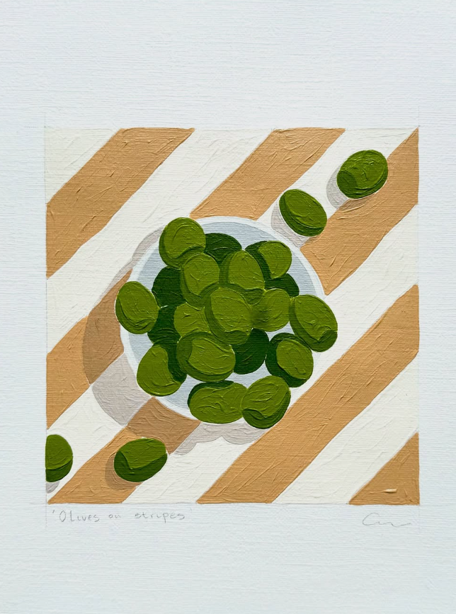 Painting of green olives placed on a striped table cloth.