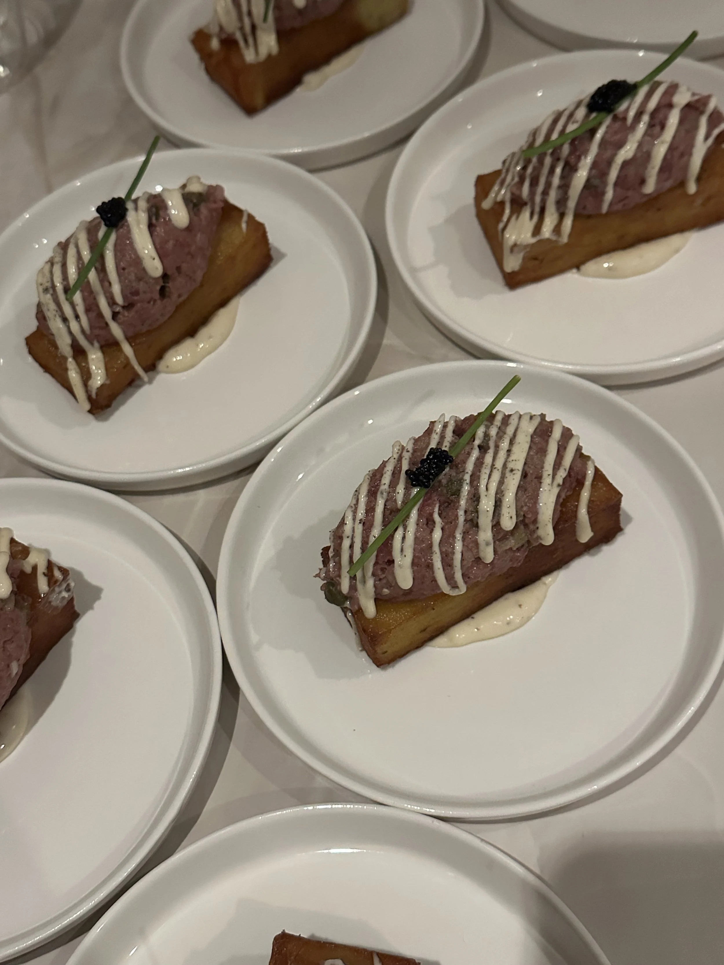MILLEFEUILLE MET STEAK TARTARE   Krokantje van dunne laagjes aardappel met daarop steak tartare, afgemaakt met truffelmayonaise en kaviaar