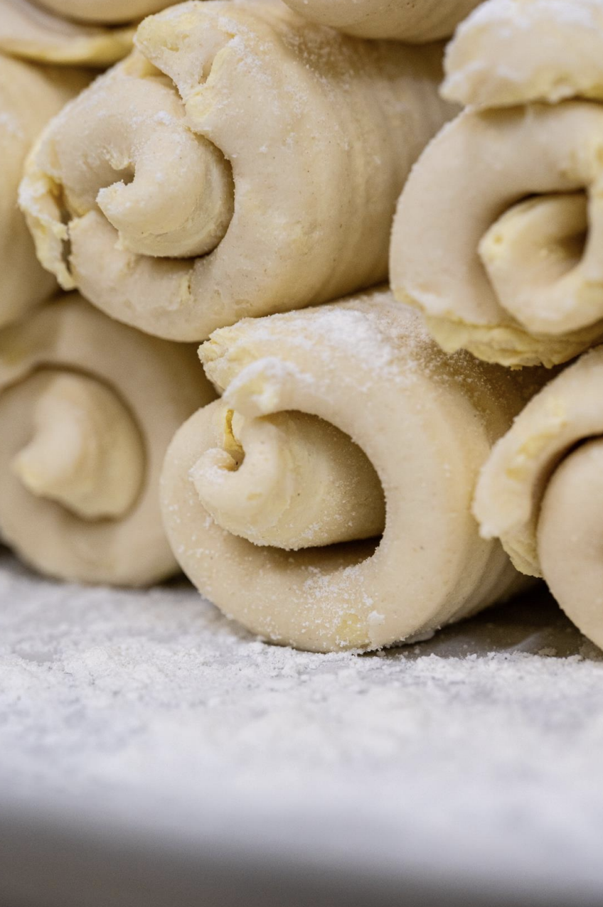 Uncooked rolled dough with flour dusting.