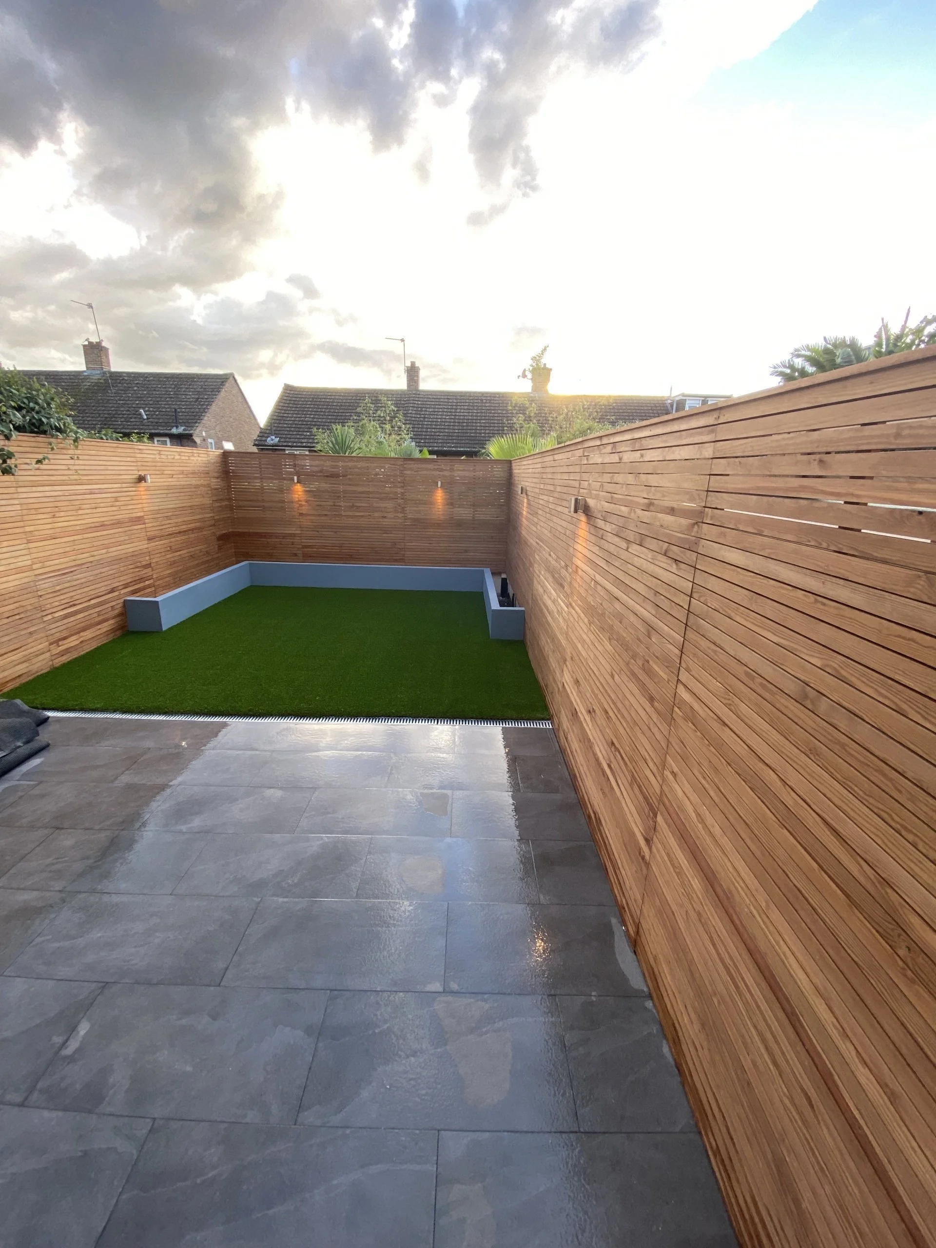 Landscaped rear garden with new patio, lawn and timber fencing by RELM Interiors