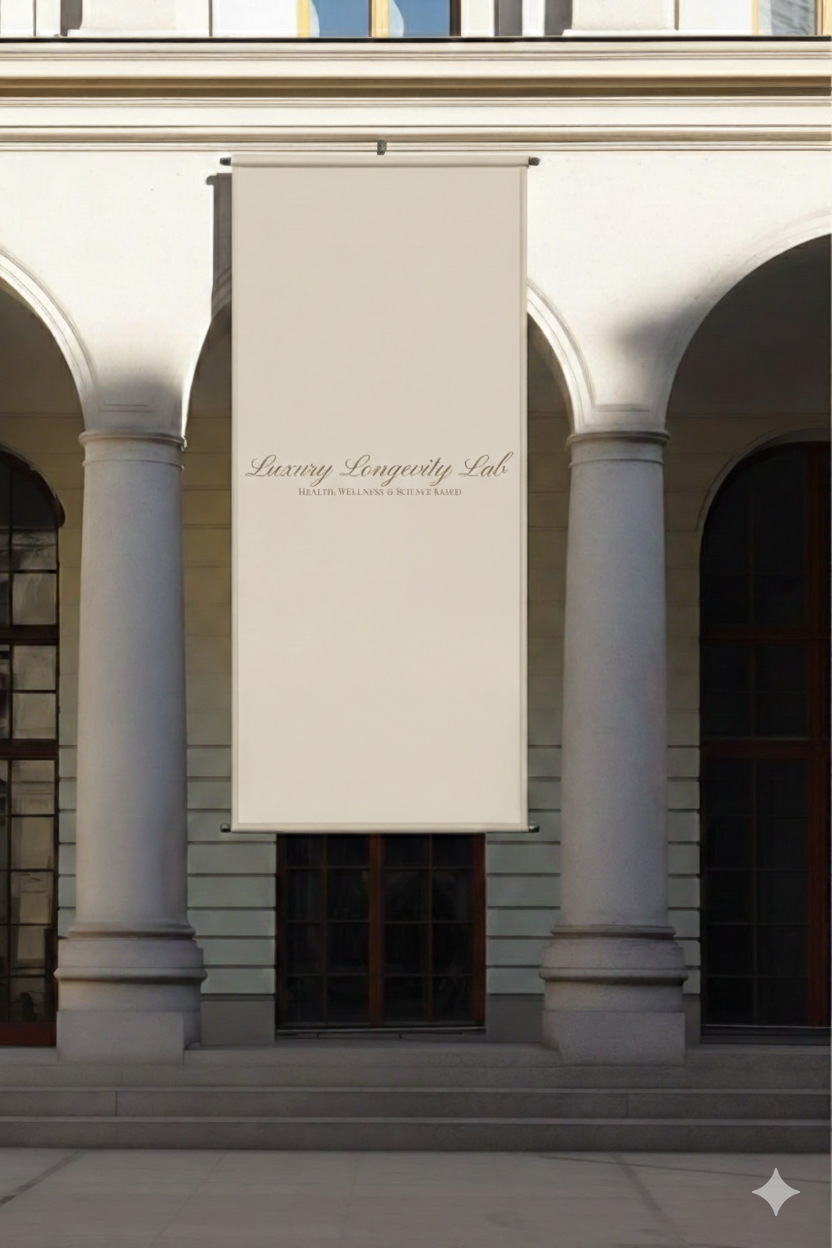 A large white banner hanging between two tall columns in front of a building, with the text 'Luxury Longevity Lab' and smaller text 'Health, Wellness & Rejuvenation'.