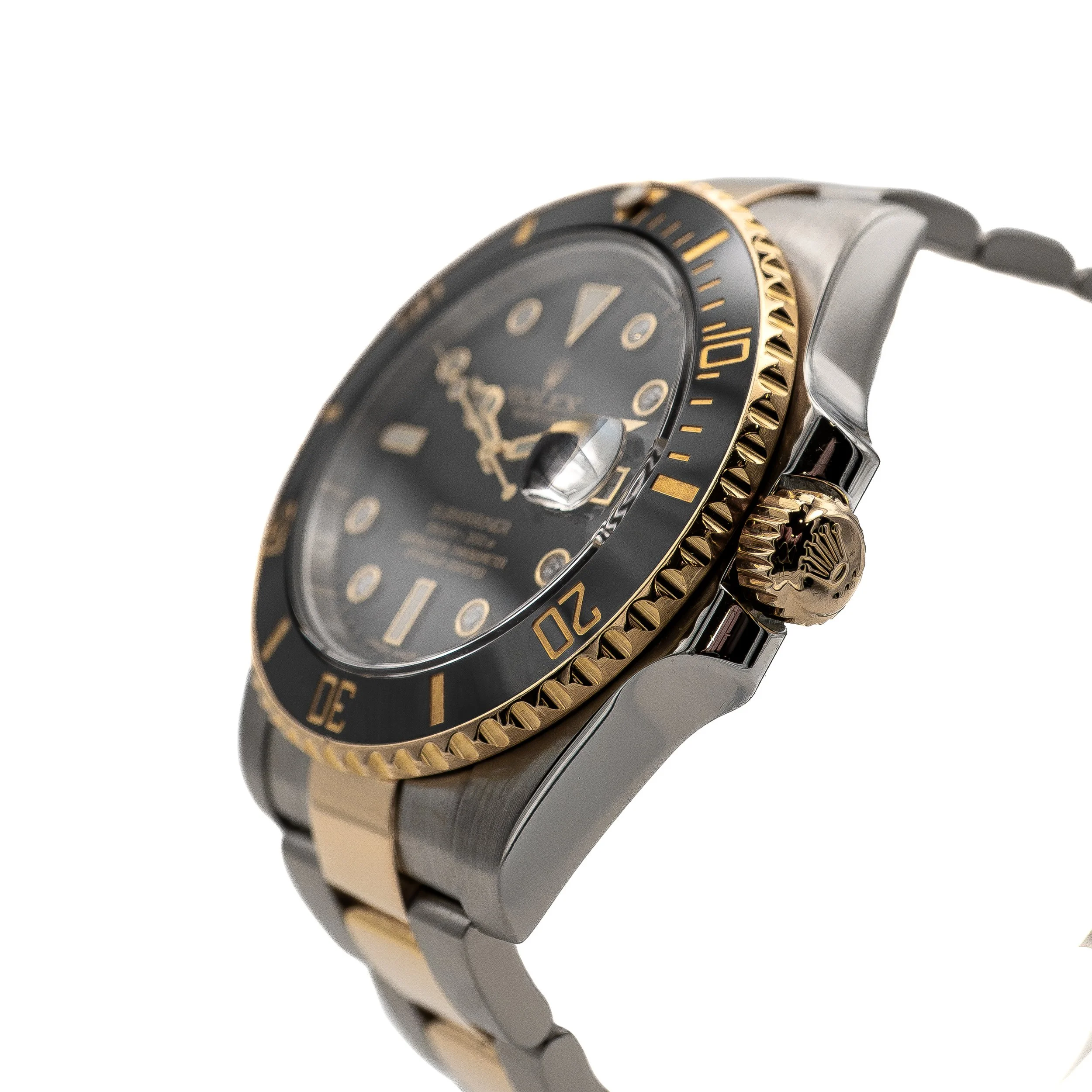 A close-up of a luxury wristwatch with a black dial, gold bezel, and two-tone metal bracelet.