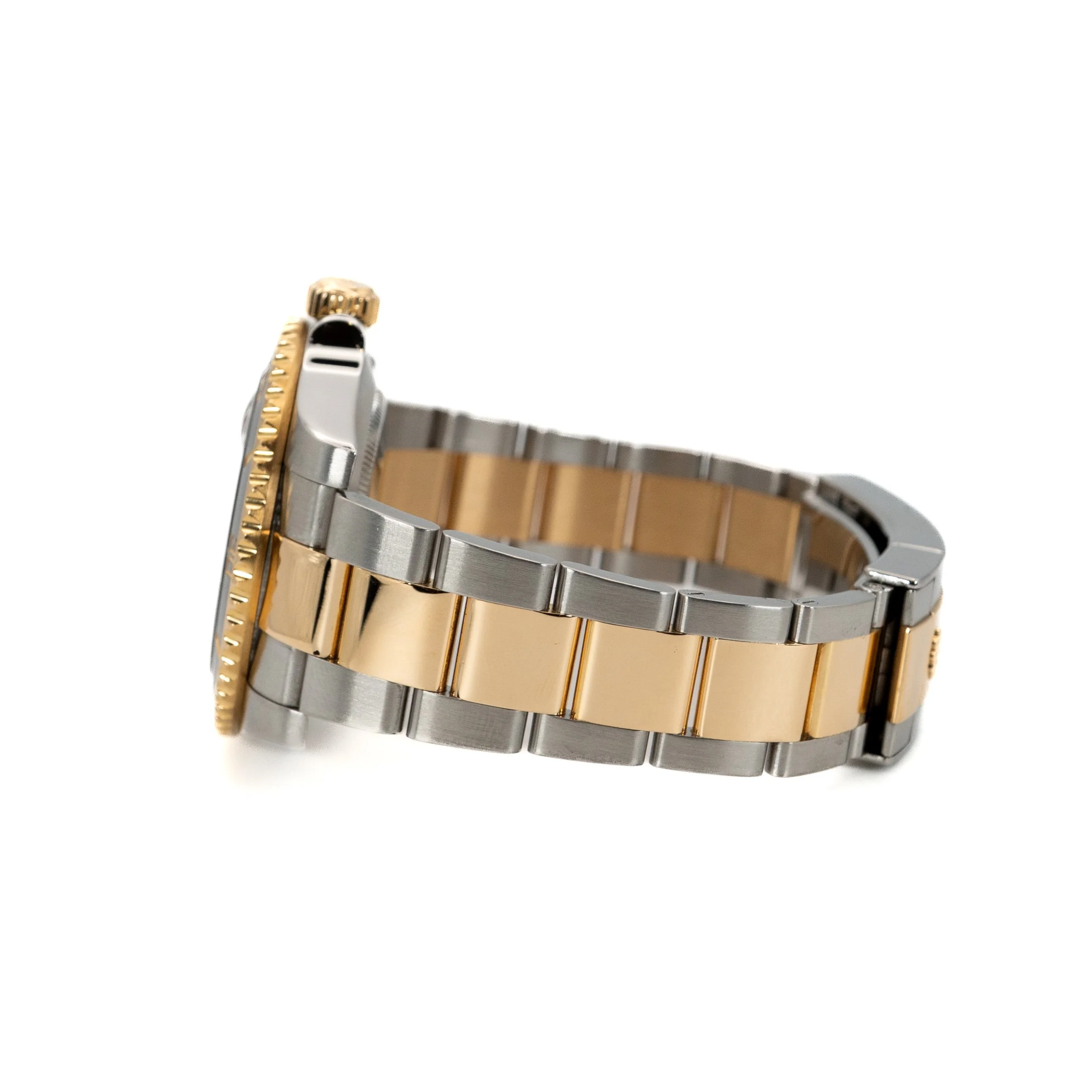 Side view of a two-tone metal wristwatch with a gold and silver bracelet and a gold bezel.