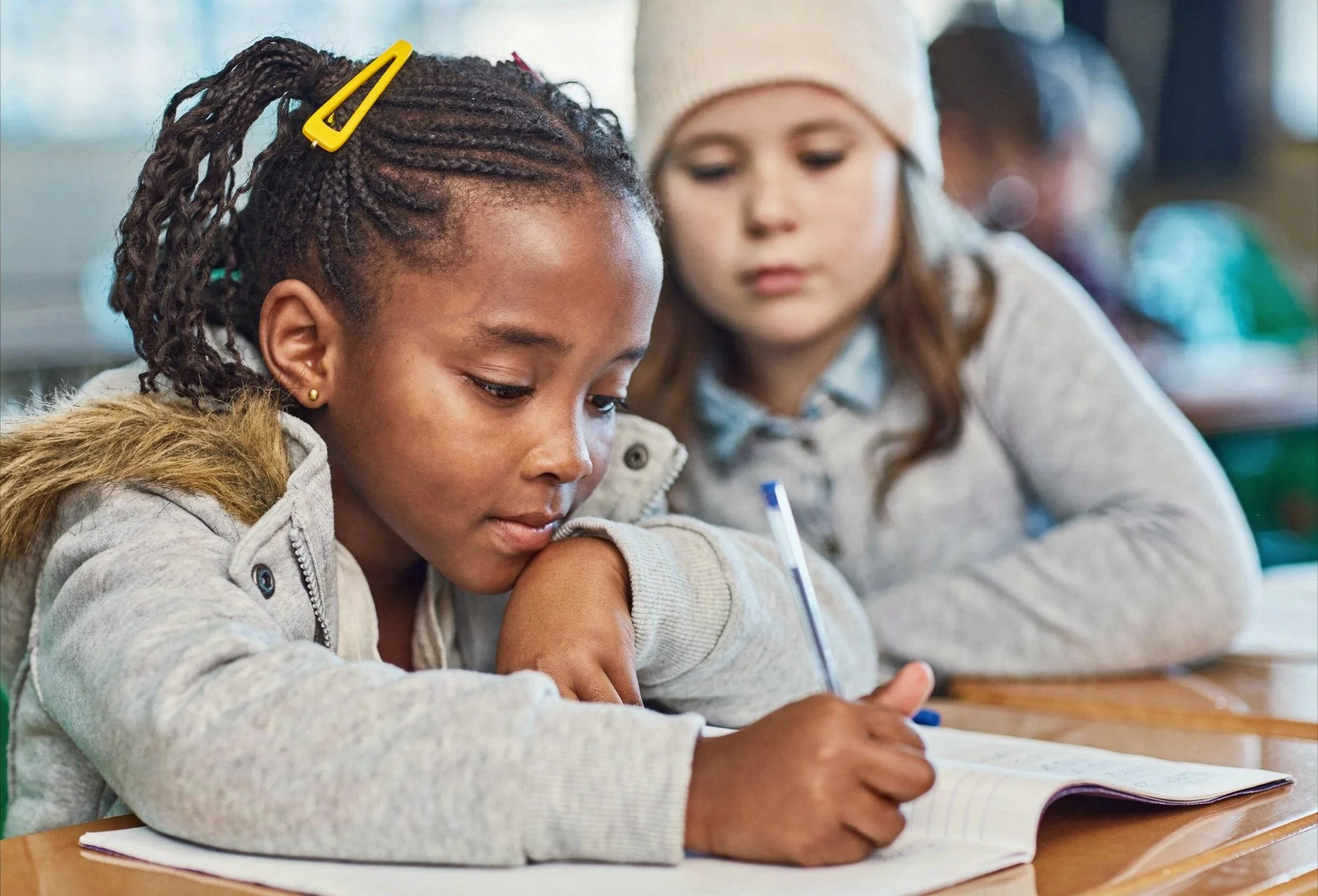 2 young girls working on a writing assignment