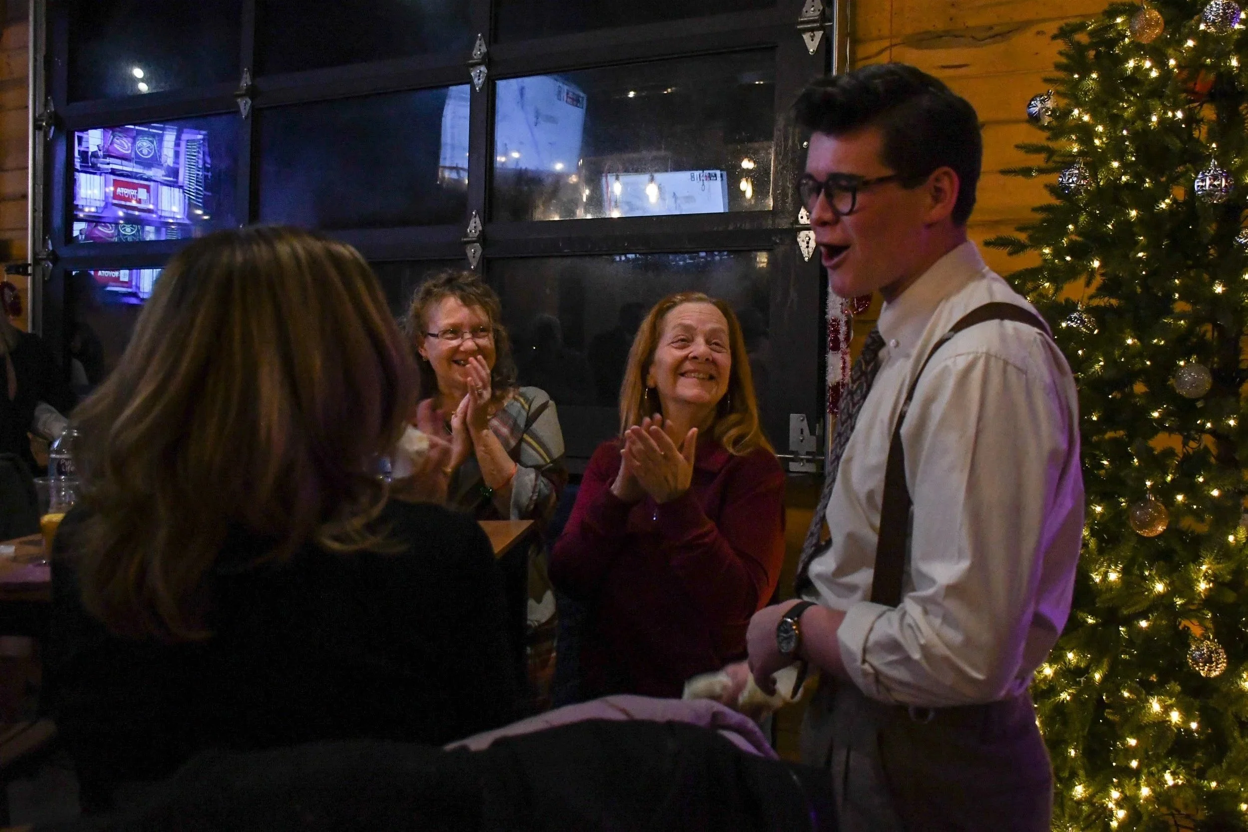 Liam Abner entertaining guests at a private Christmas party-holiday event magician Denver Colorado