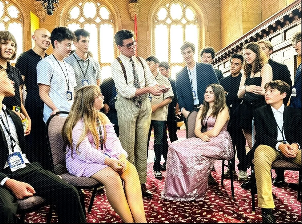 Liam Abner performing parlor magic for a group at an elegant private venue