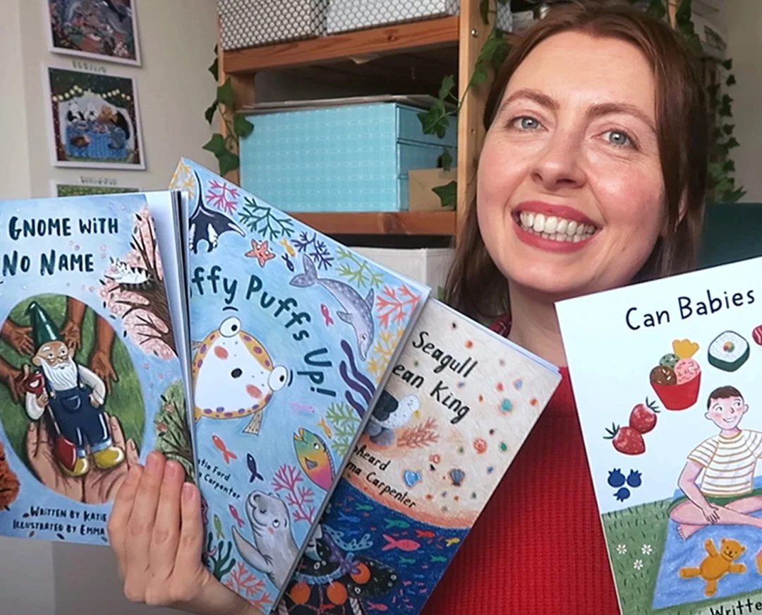 Emma Carpenter a picture book artist holding children's books she has illustrated