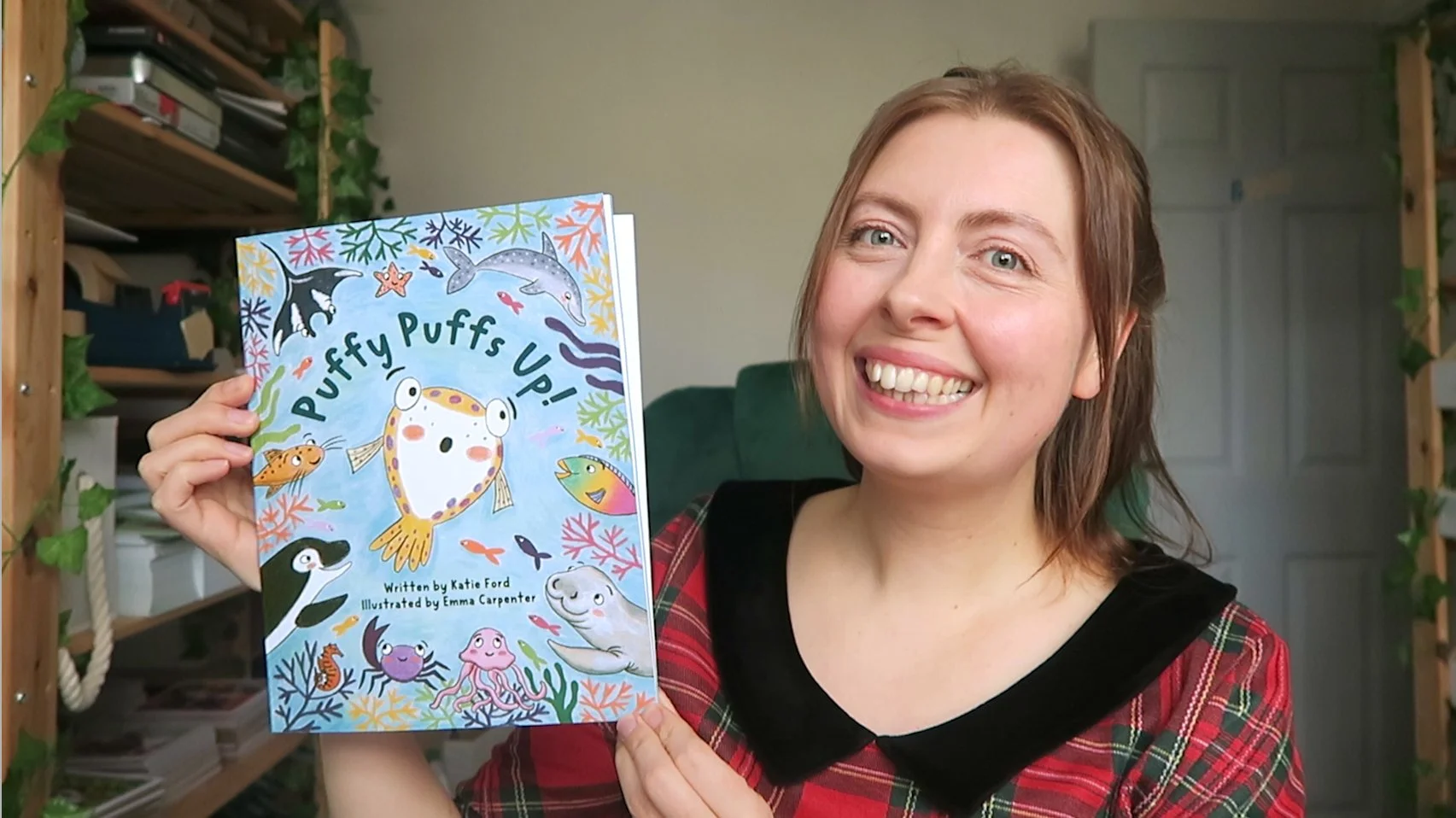 Emma Carpenter children's story book artist holding finished copy of picture book Puffy Puffs Up!