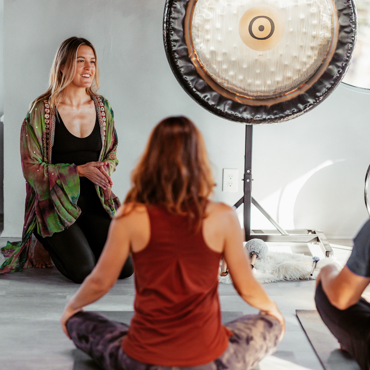Winter Harvey leading a small group session with sound healing gong