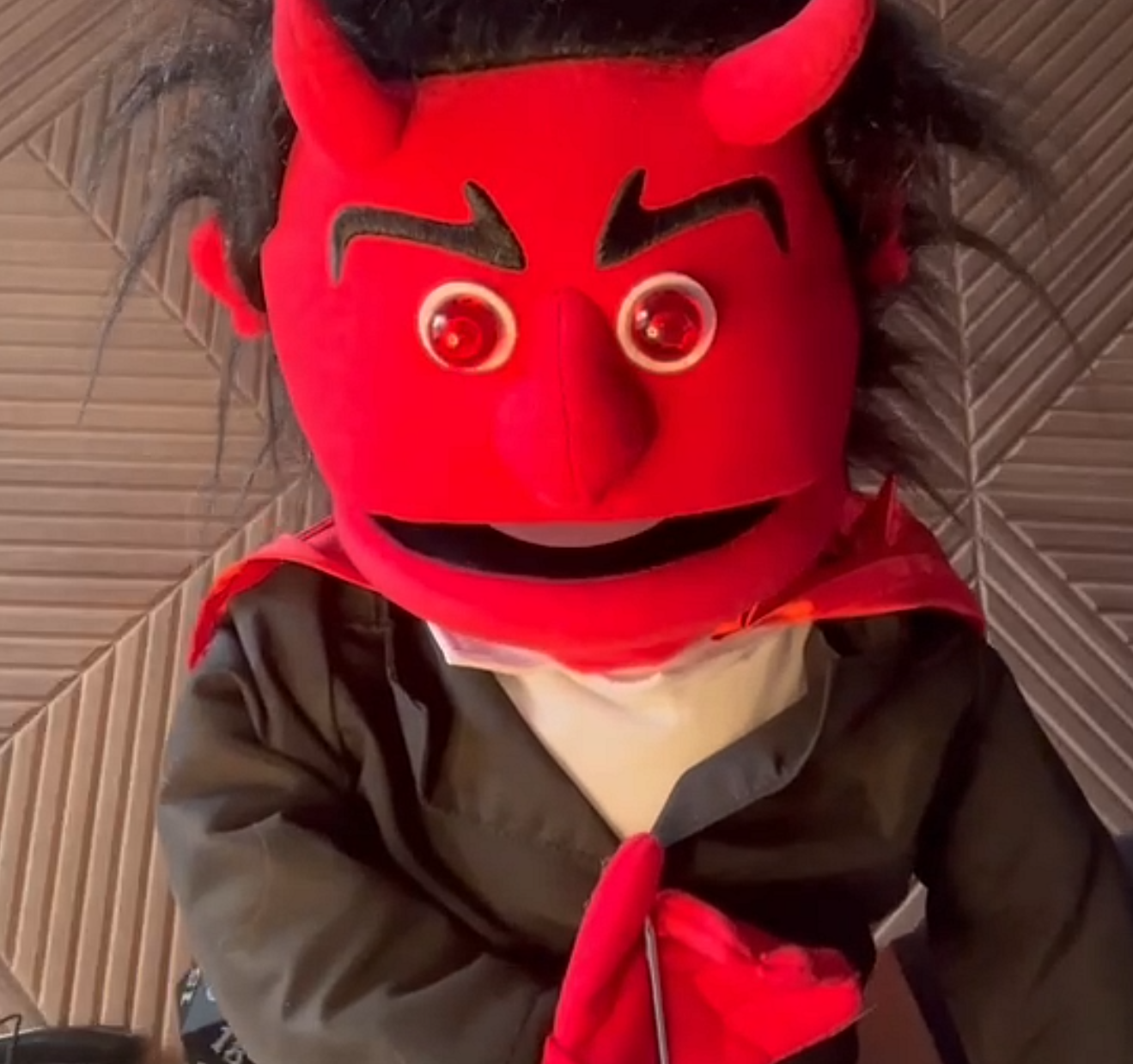 Triangle QuestHouse's unofficial devil puppet mascot, a red horned character often featured at community events