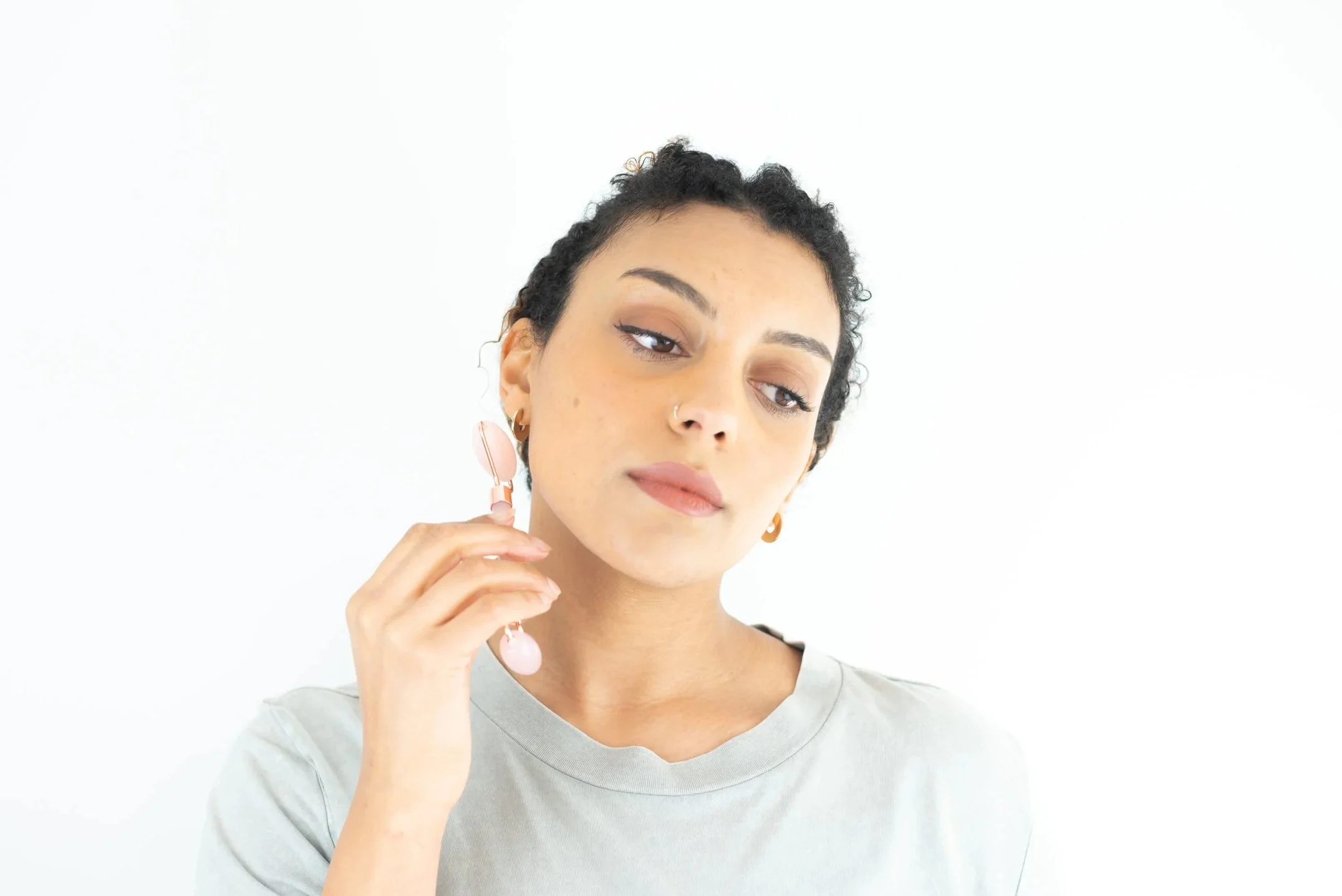 Photoshoot of model using a product to improve skincare routine