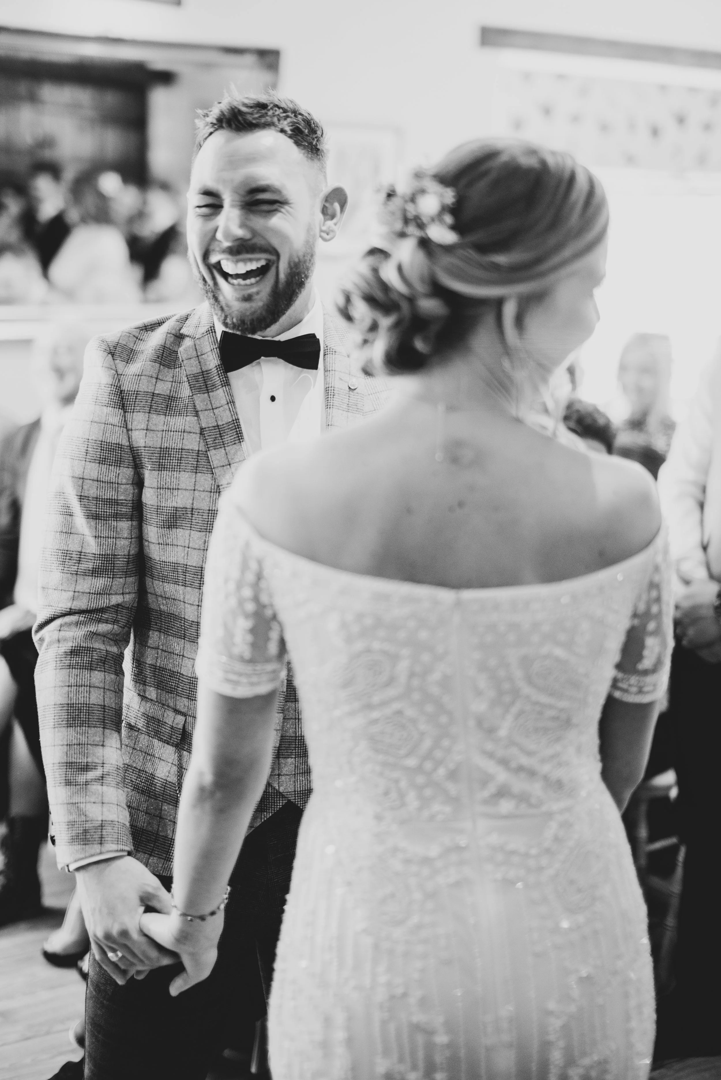 Groom laughing at top of aisle in Moonraker Hotel in Bradford on Avon