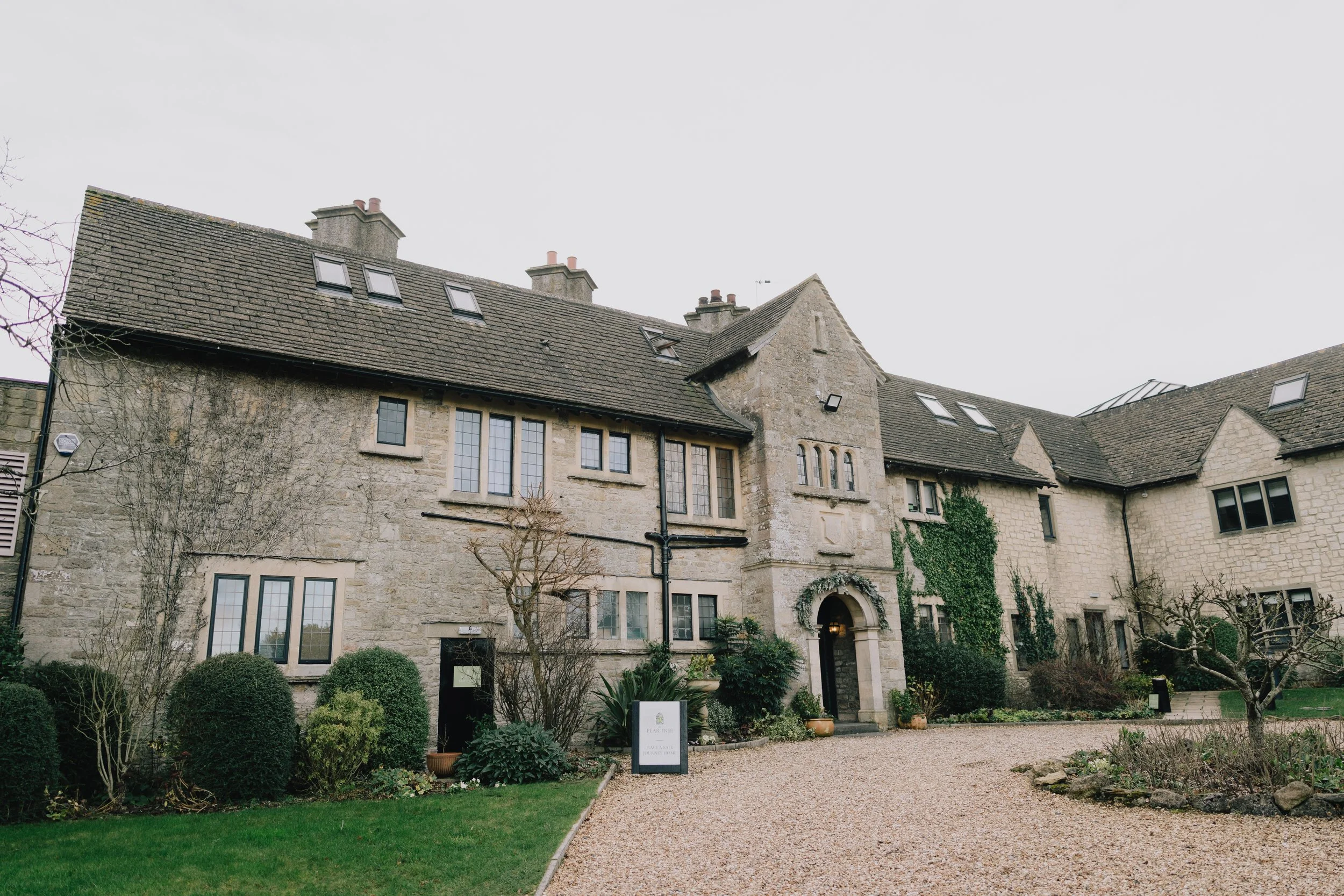 Exterior view of The Pear Tree, Purton — a romantic Wiltshire wedding venue set in a 400-year-old former vicarage with landscaped gardens and vineyard.