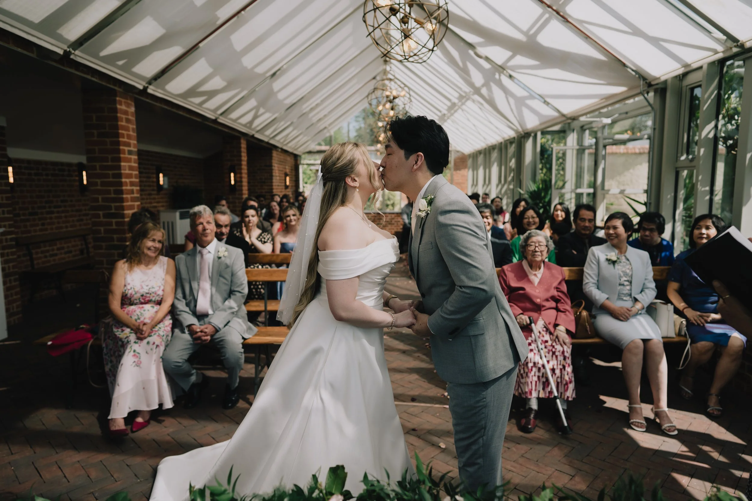 Bride and Groom kissing after being pronounced husband and wife at syrencot wedding venue