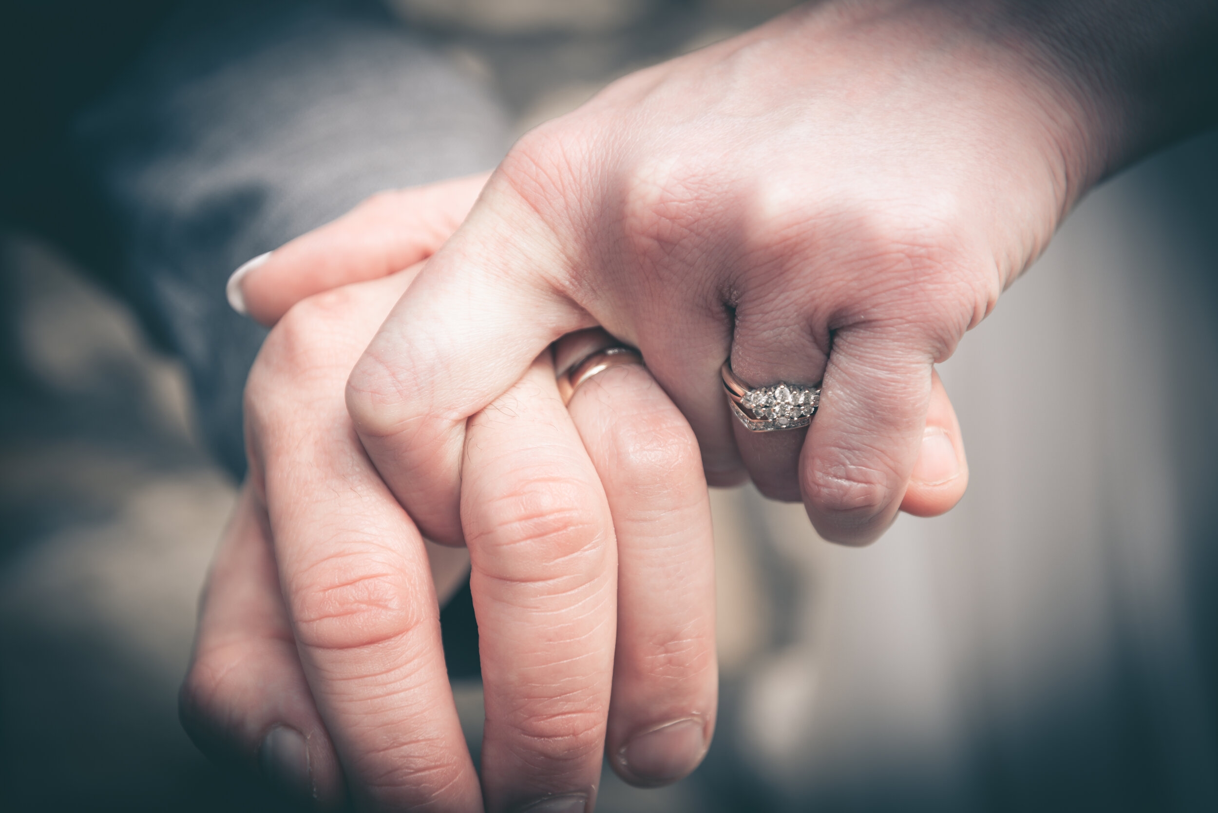 Bride and groom holding hands as a sign of commitment for the rest of their lives