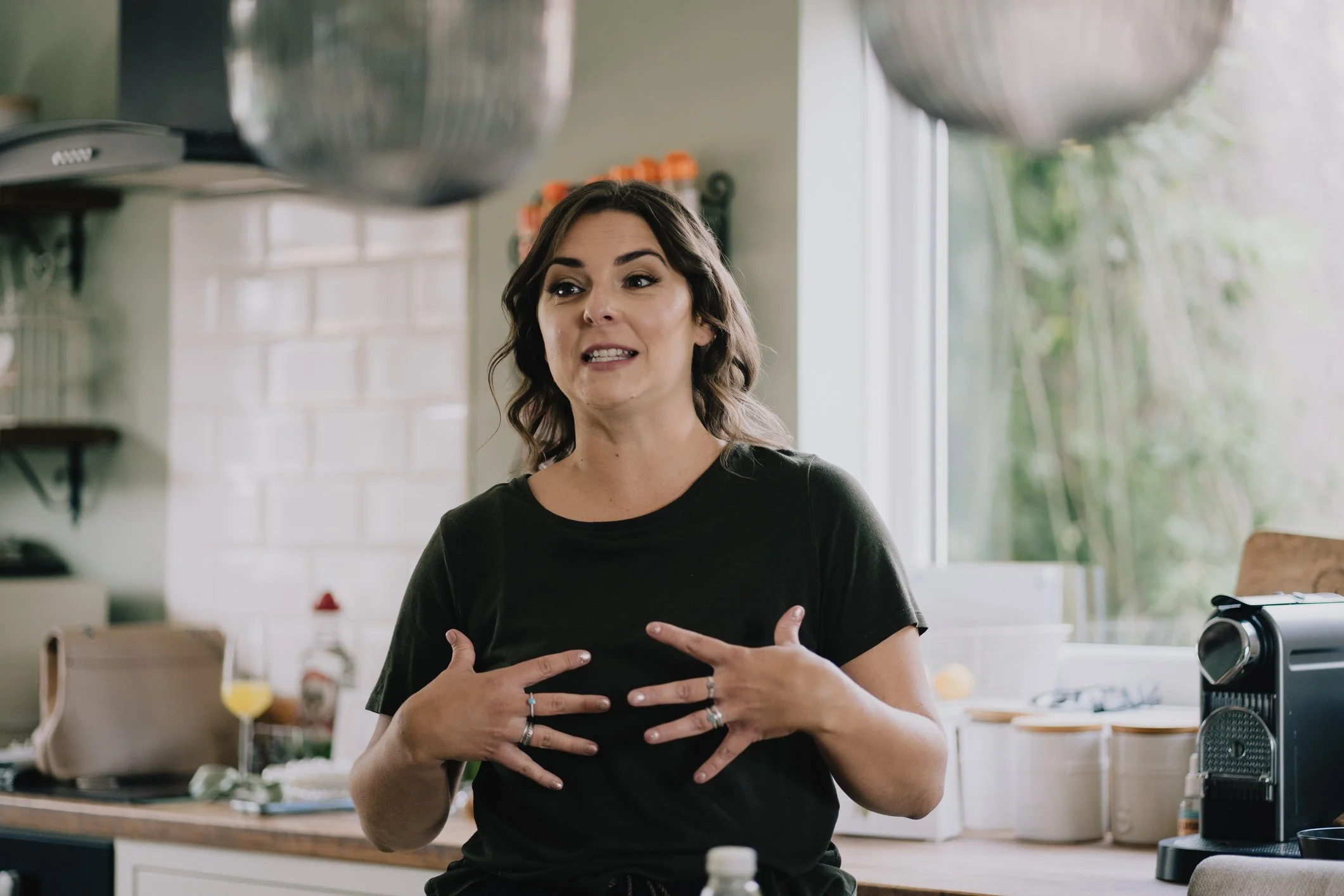Documentary Wedding Photographer in Bristol capturing bridesmaid gesturing to bride with cheeky facial expression