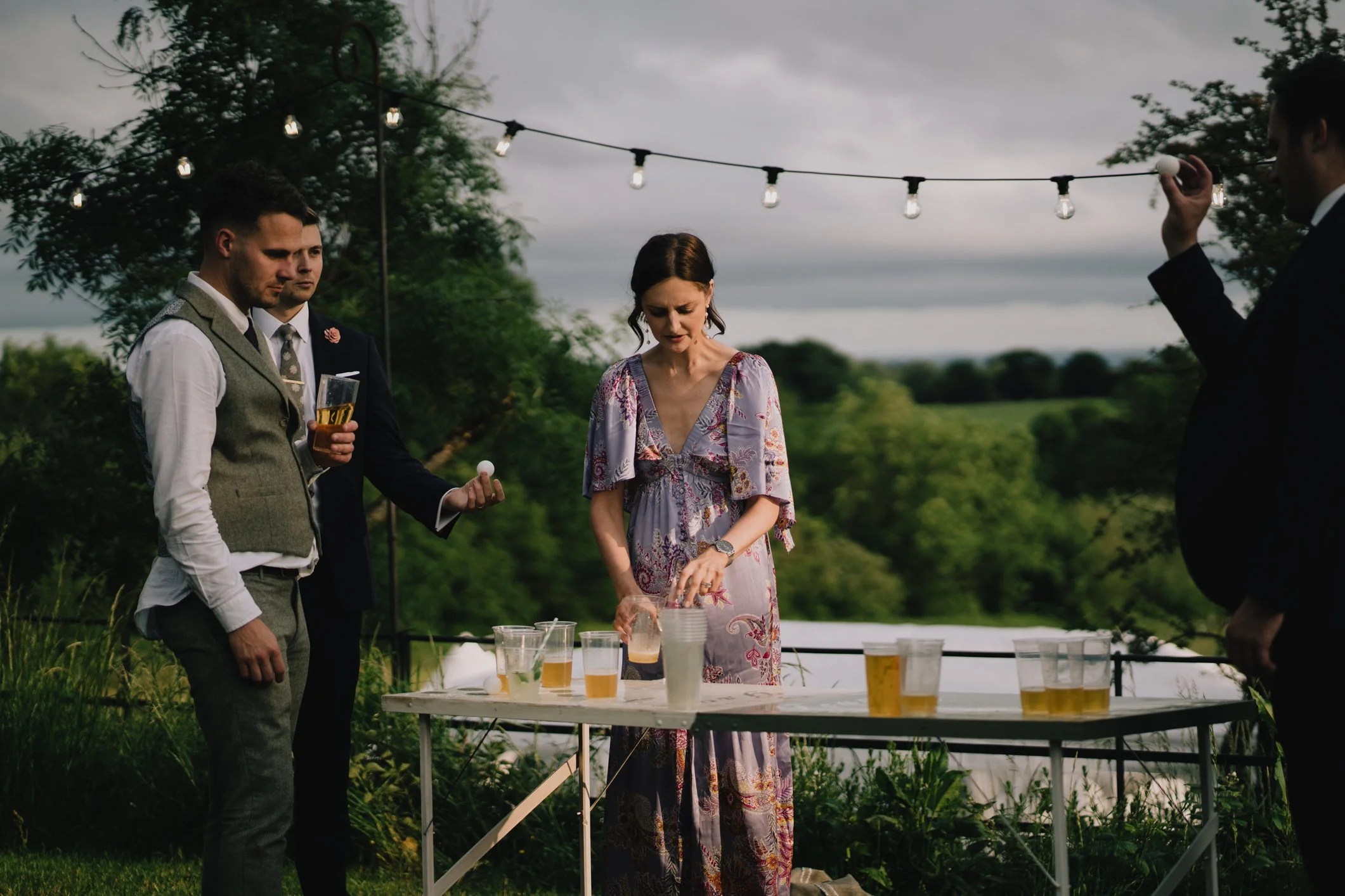 Documentary Wedding Photographer in Bristol capturing guests playing beer pong at Lapwing Farm
