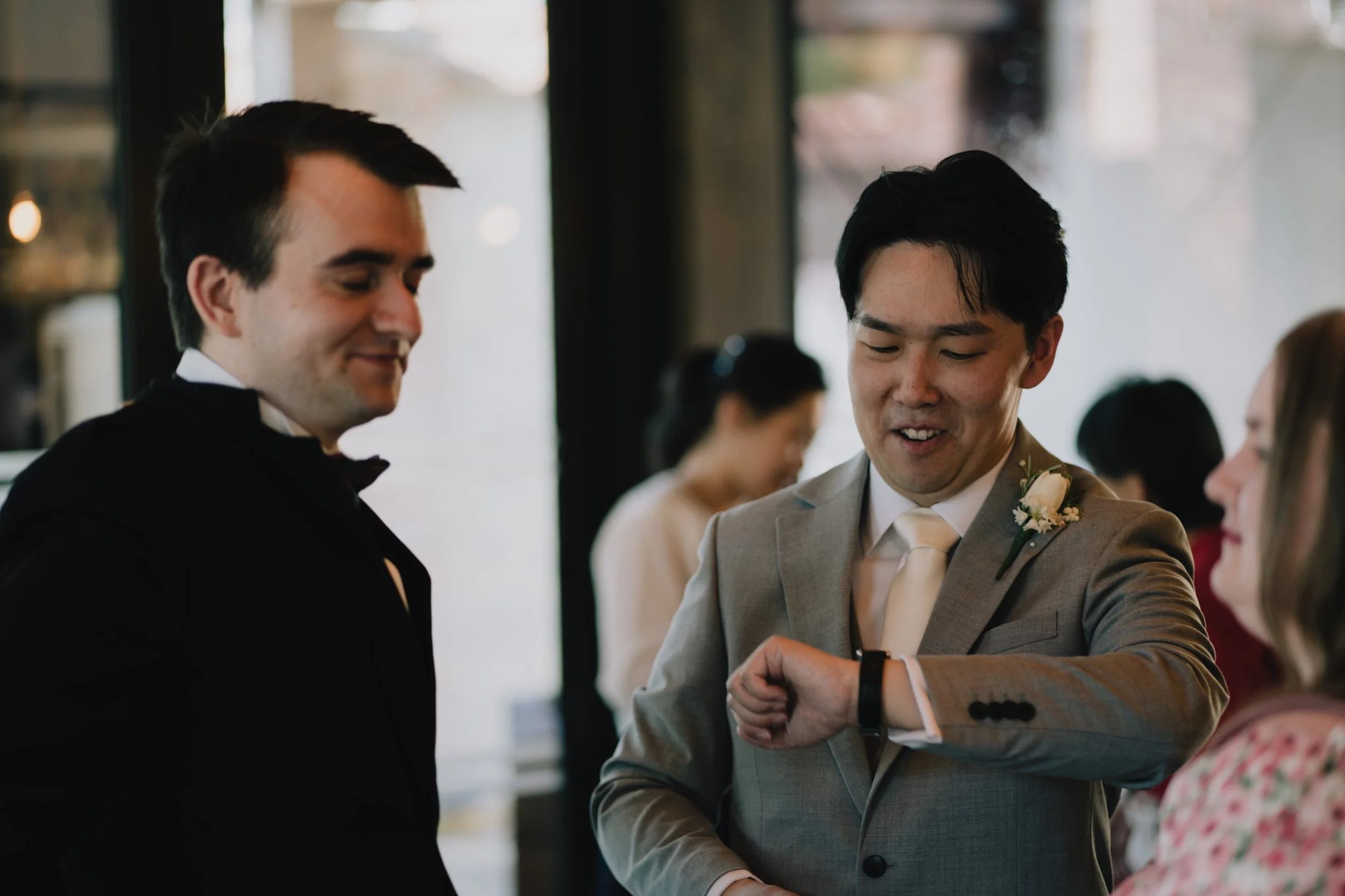Documentary Wedding Photographer in Bristol capturing groom looking at his watch waiting for the bride at Syrencot