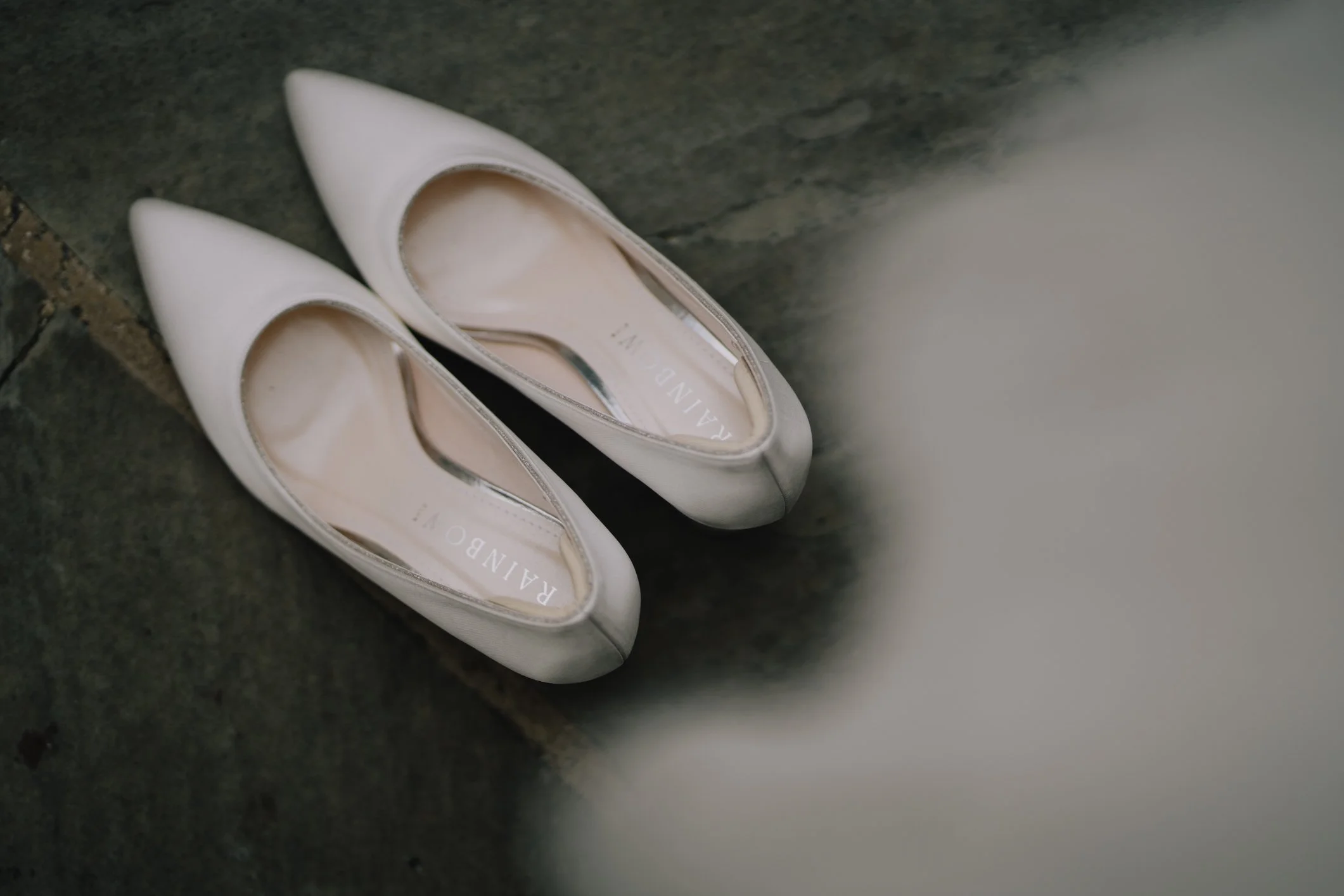 Close-up of bridal shoes carefully placed in the prep room before the ceremony
