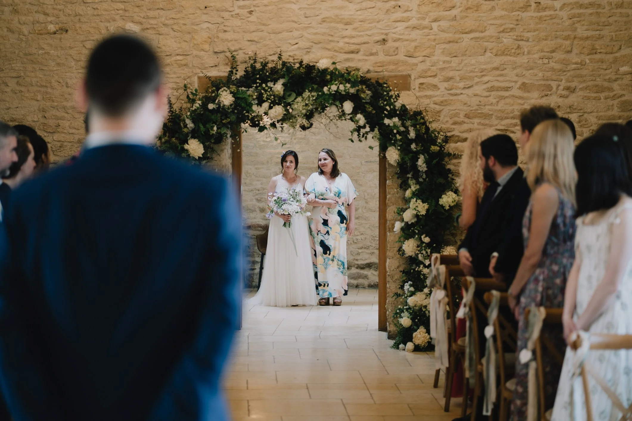 Bride and her mum sharing a quiet, emotional moment before entering the ceremony room