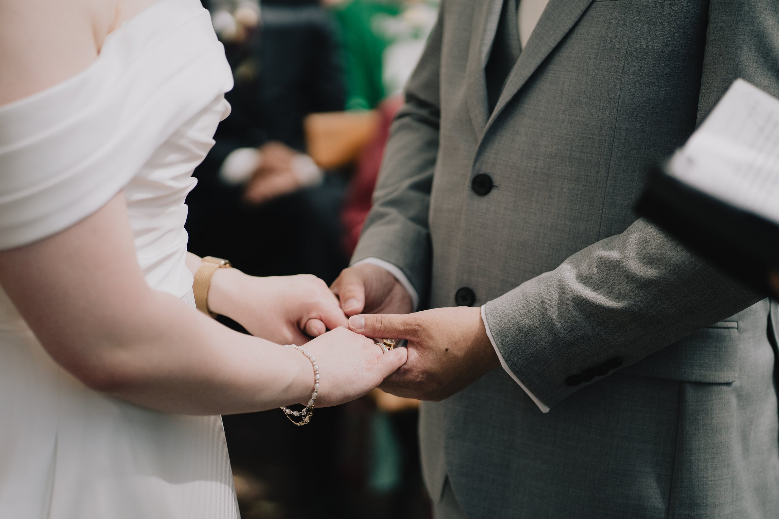 Close-up of bride and groom holding hands during intimate moment at Syrencot wedding