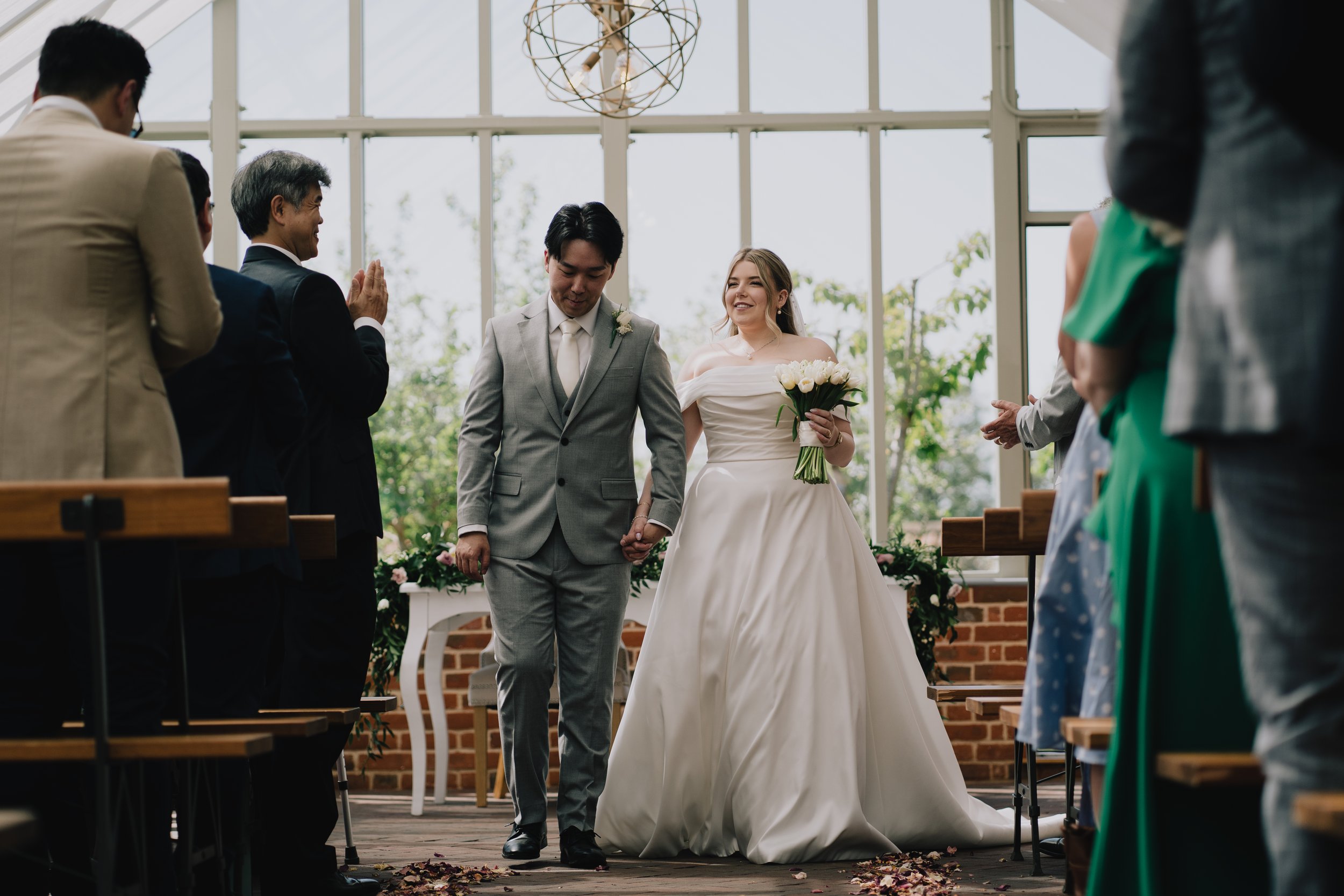 Bride and groom walking hand-in-hand just after wedding ceremony at Syrencot