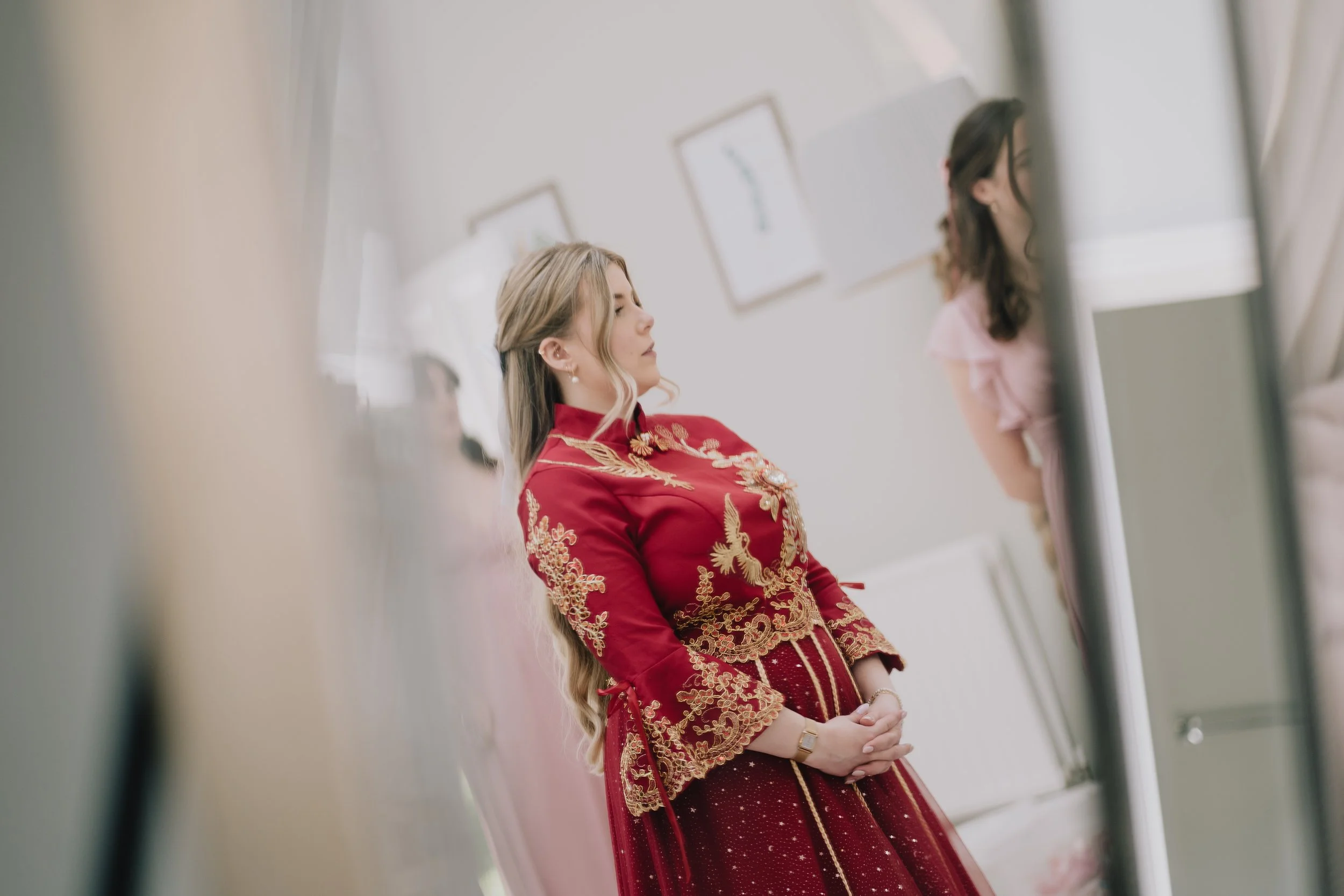 Bride Lucy participating in traditional Chinese tea ceremony during Syrencot wedding