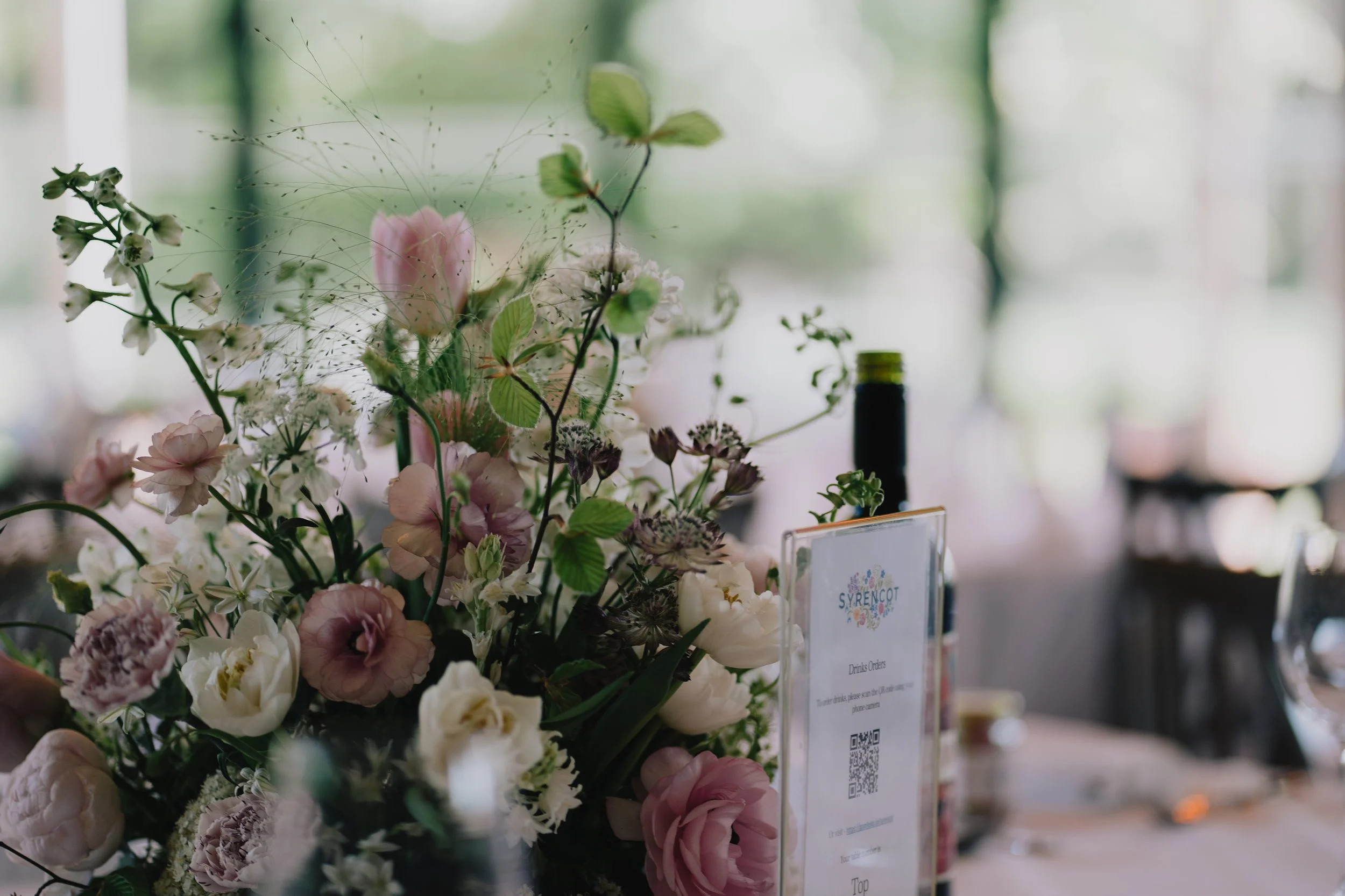 Close-up of elegant wedding flower centrepiece at Syrencot wedding breakfast