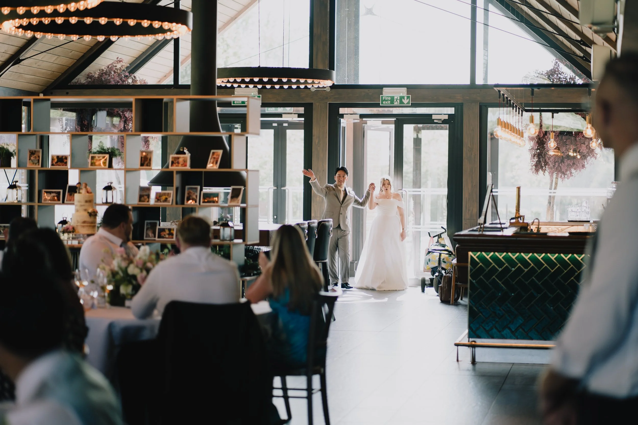 Bride and groom entering Farmshed at Syrencot for wedding breakfast to applause