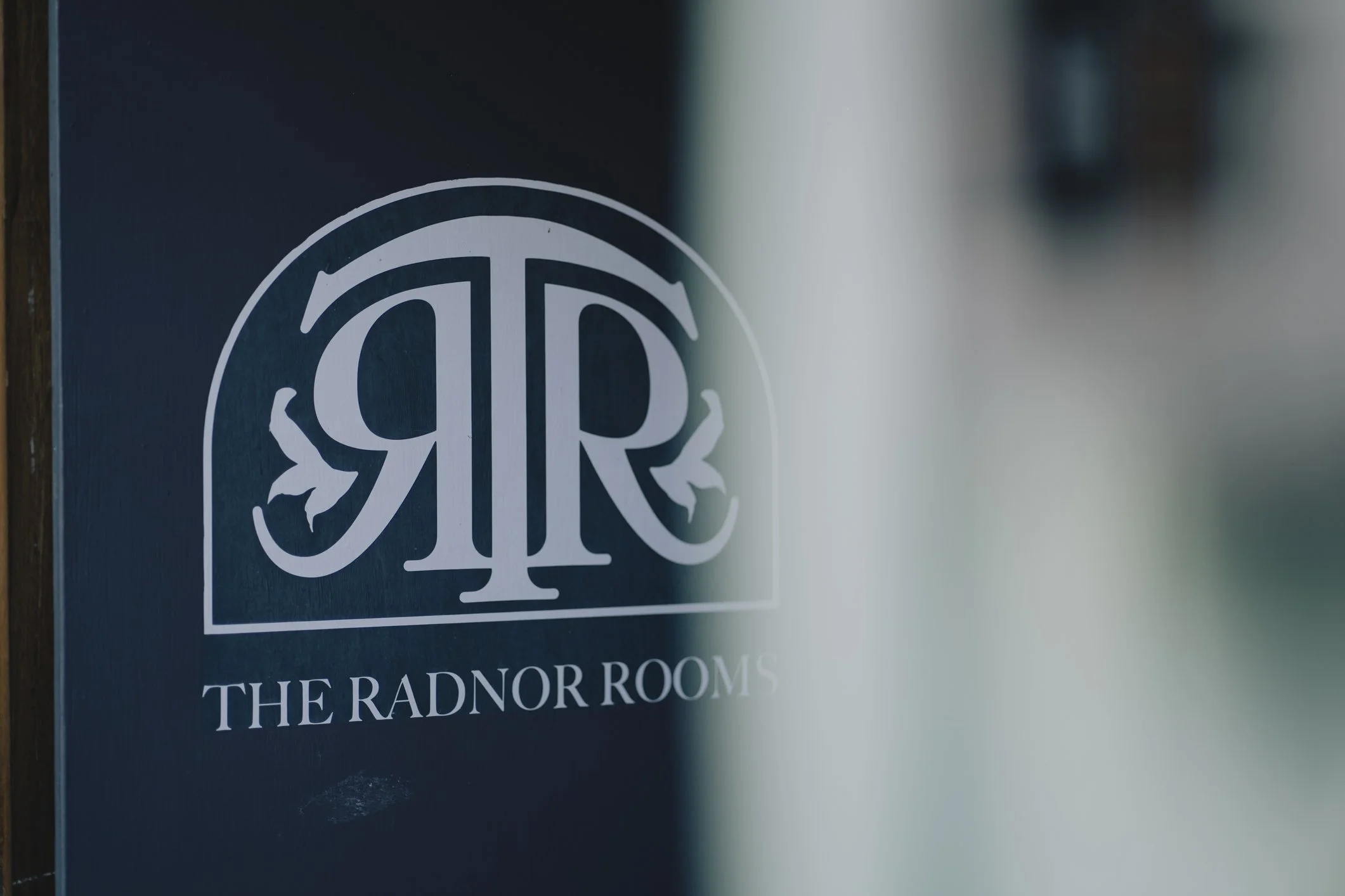 Sign for The Radnor Rooms with a decorative logo