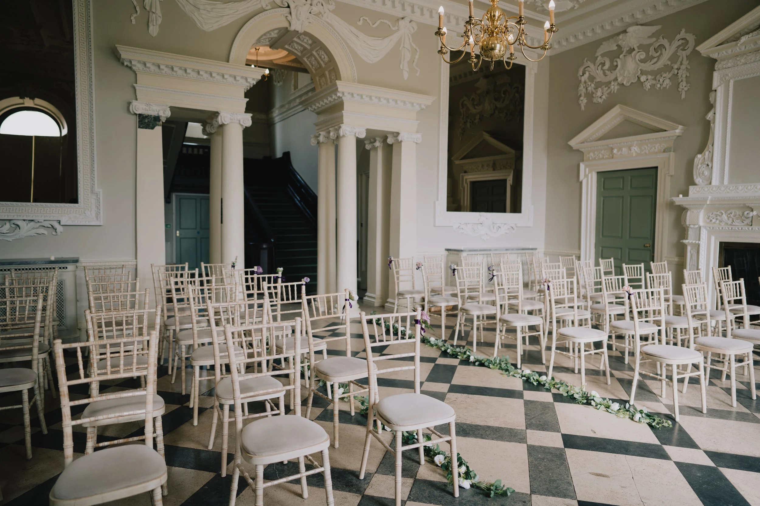 Ceremony room at Crowcombe Court set up before guests arrive – elegant chairs, florals and natural light in a romantic setting.