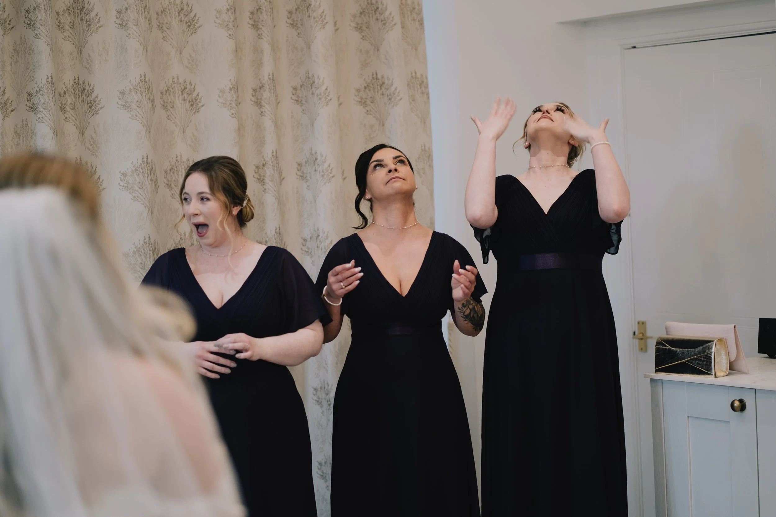 Bride's emotional first look with bridesmaids at Crowcombe Court, with some bridesmaids wiping away happy tears.