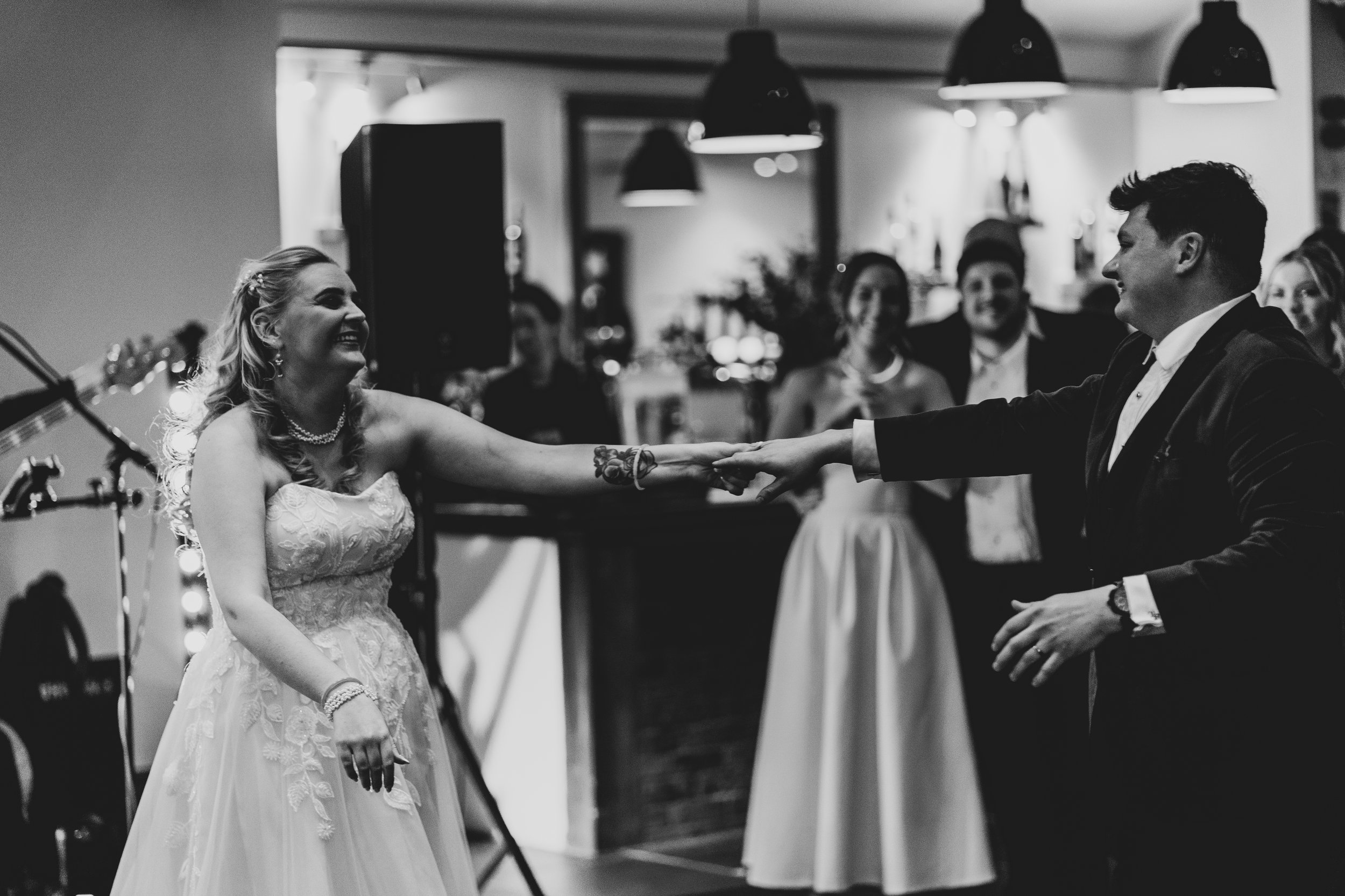 Bride and Groom dancing during first dance at Quantock Lakes in black and white