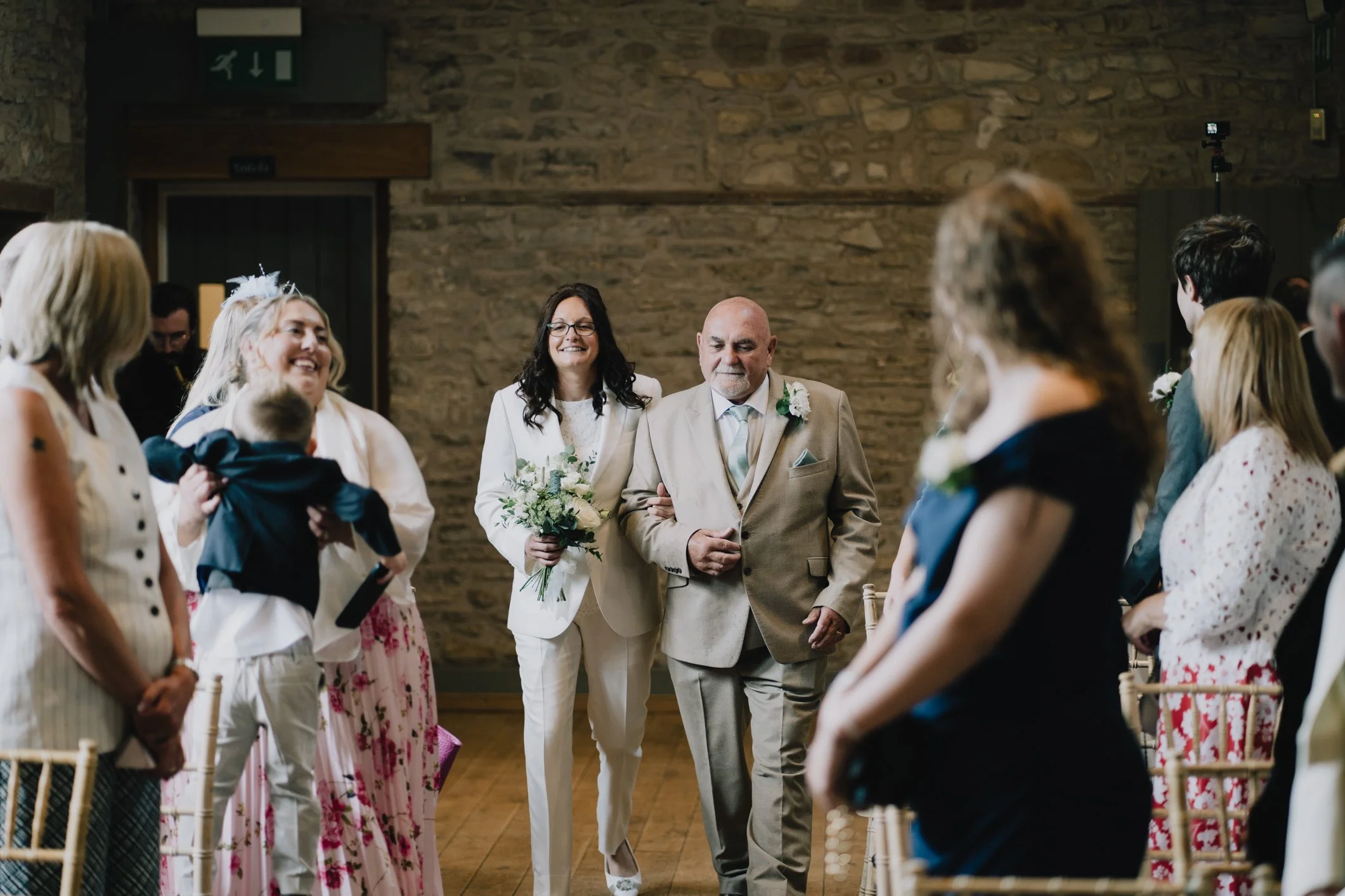 Bride walking up aisle at Folly Farm to welcome her bride to be