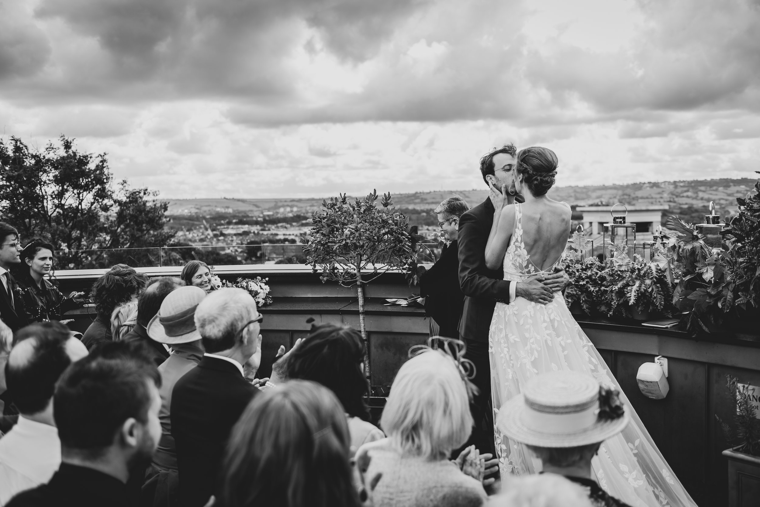 Groom greeting bride with a kiss at the altar during their Bristol wedding at Clifton Observatory.
