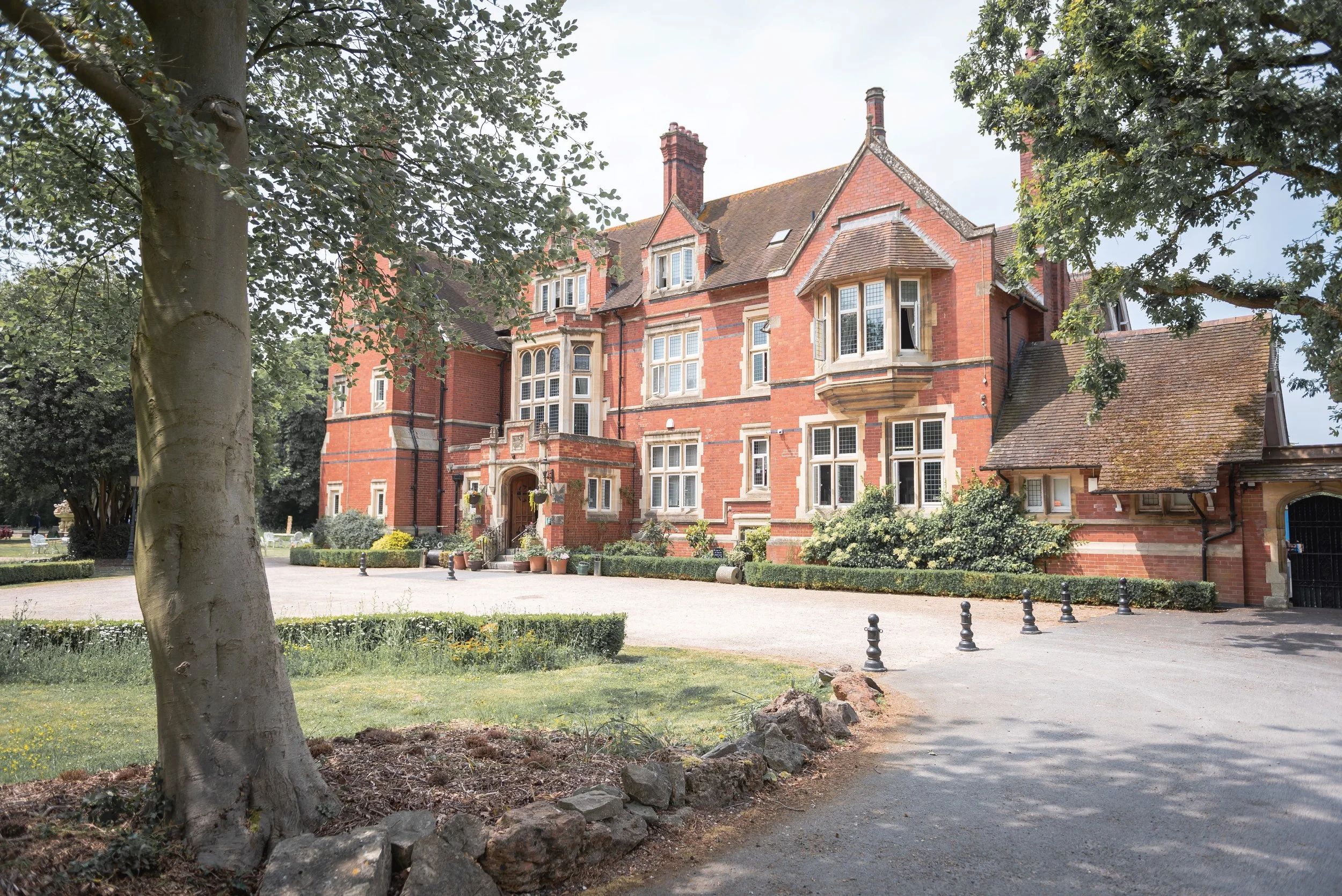 The beautiful red brick building of Berwick Lodge on a summers day ready for a wedding