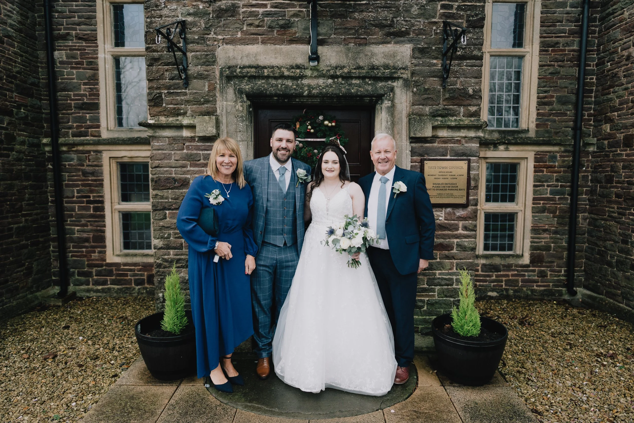 Couple and parents of the groom outside Poole Court in Yate