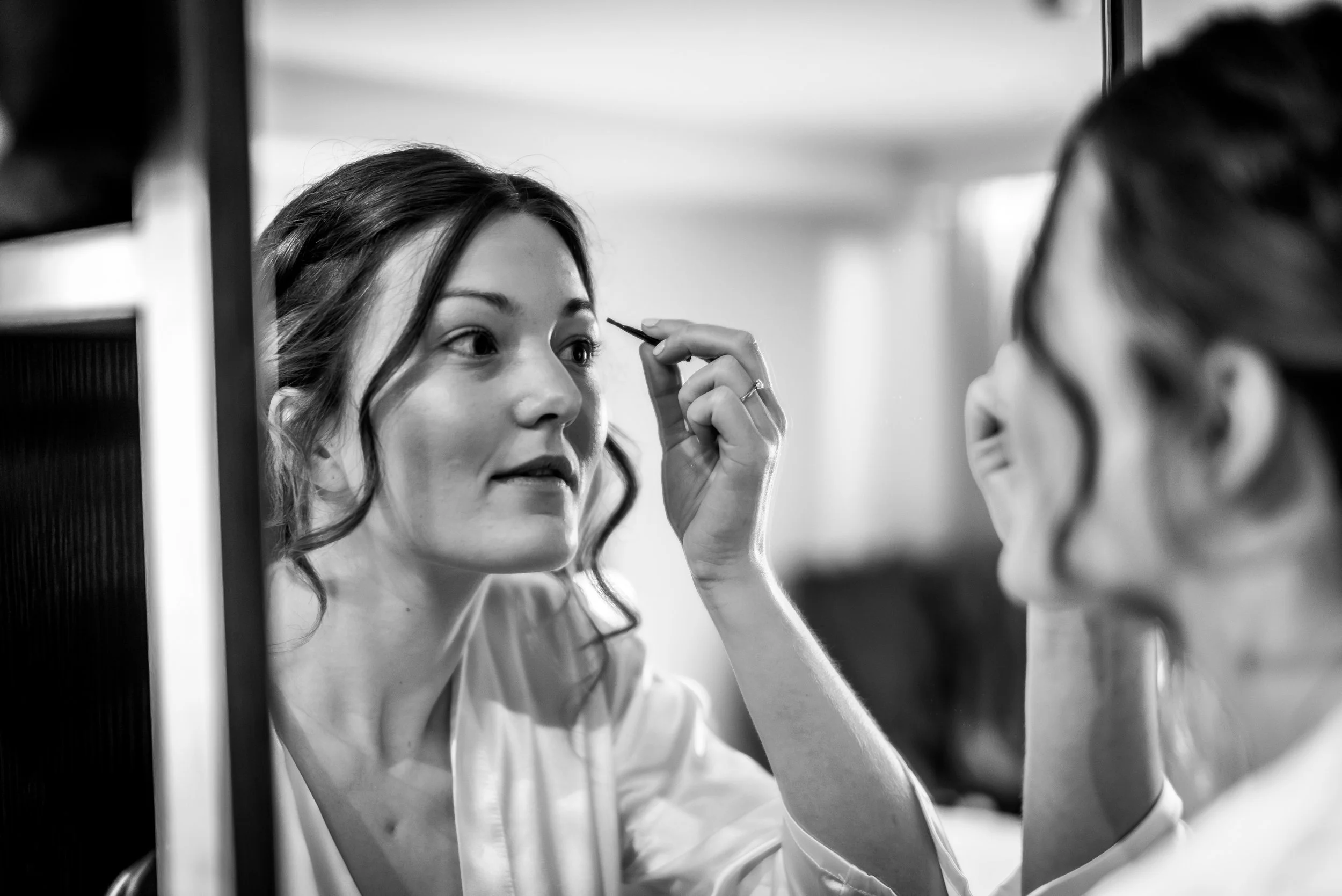 Bride applying make up before her wedding day