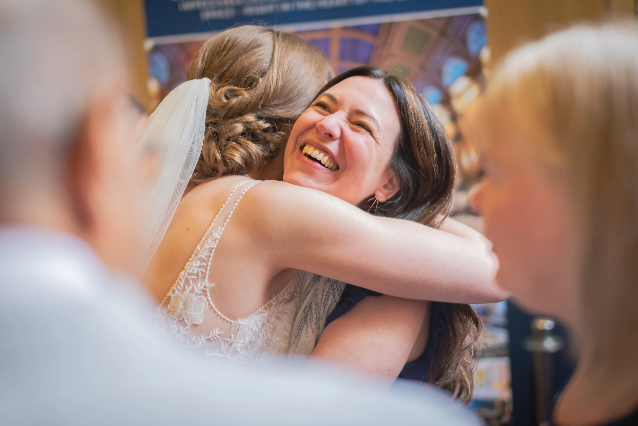 Bride smiling after getting married and being greeted by happy guests