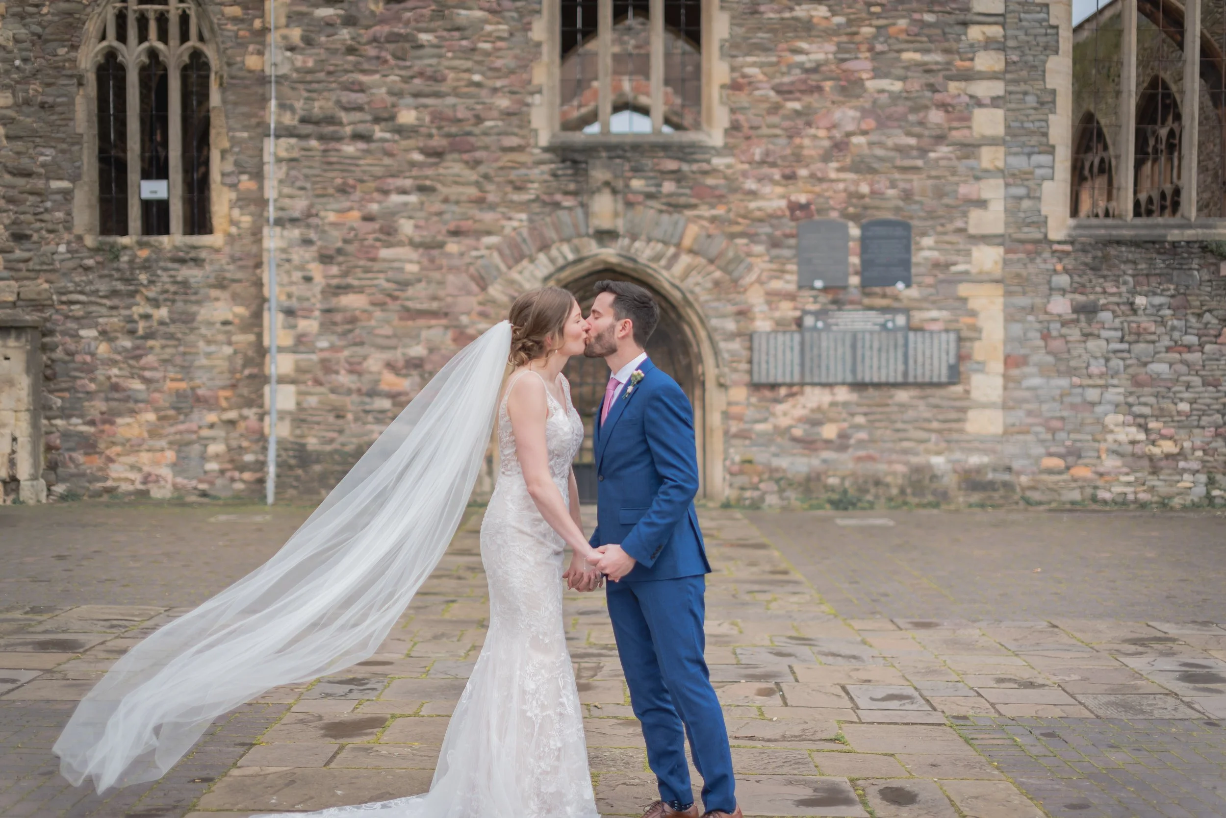 Bride and Groom kissing outside derelict church at Castle Park in Bristol