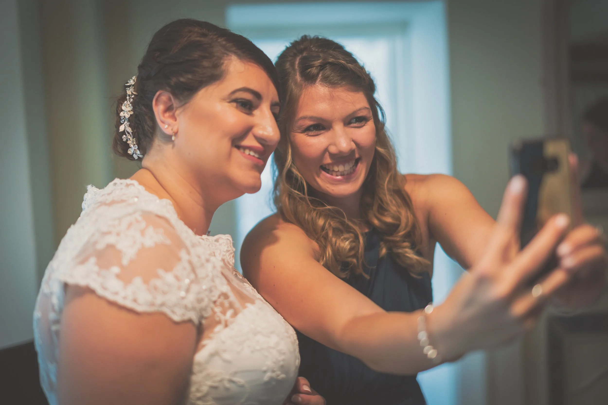 Bride and bridesmaid taking a selfie