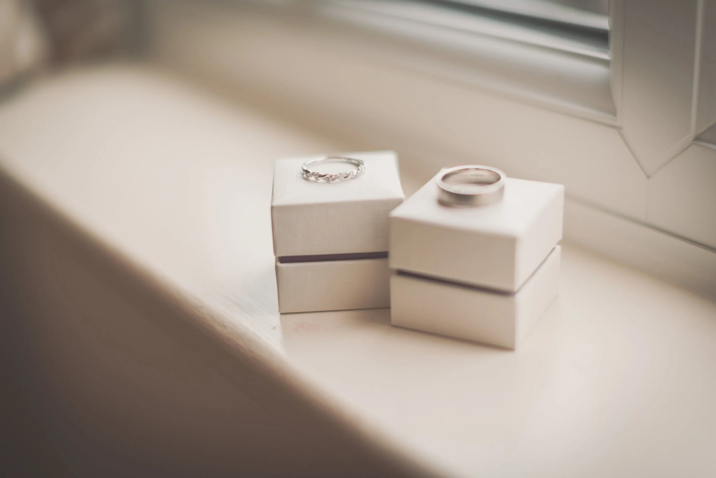 Bride and grooms wedding bands placed on top of their box