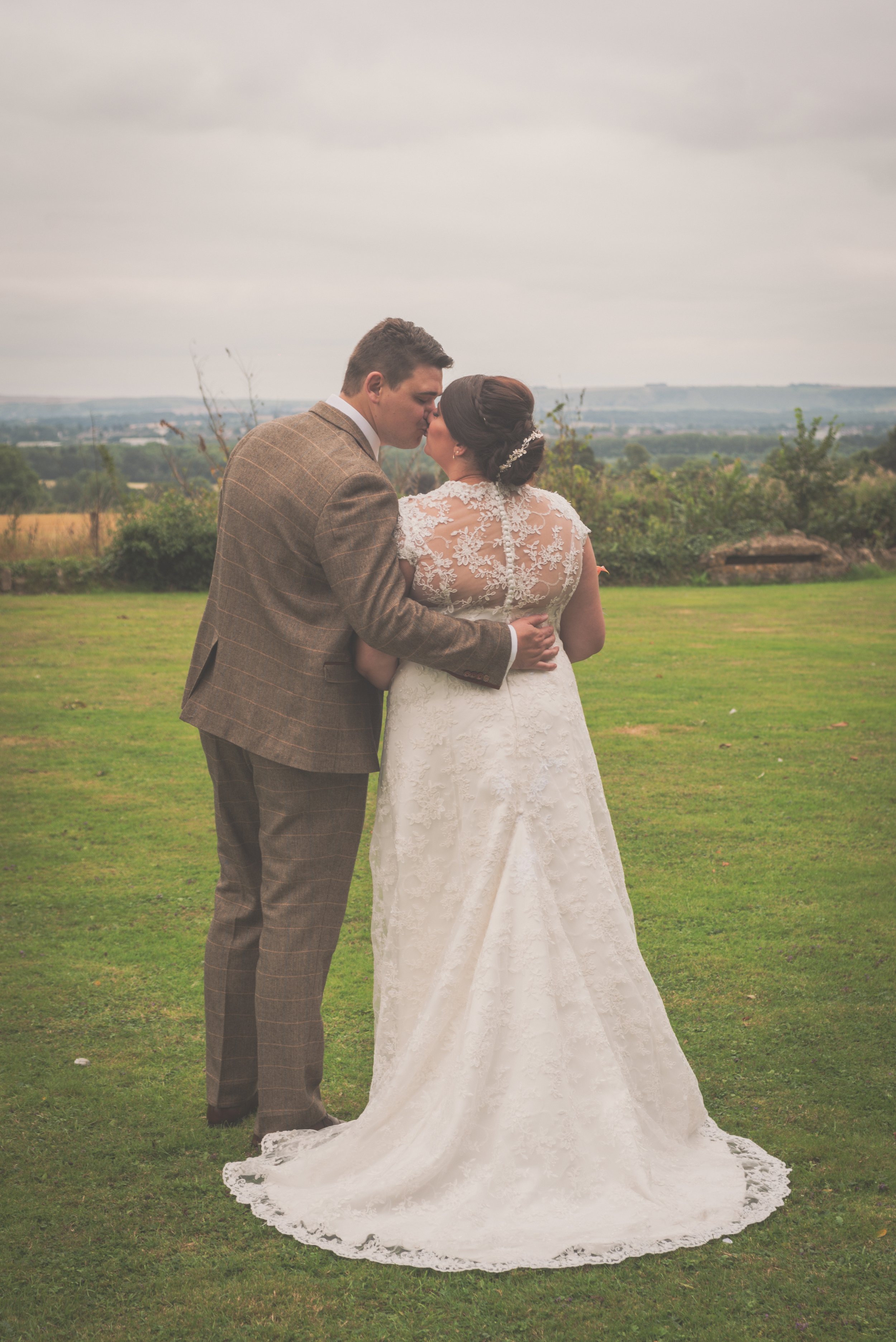 Bride and groom kissing overlooking the surrounds of Bristol at Aldwick Estate